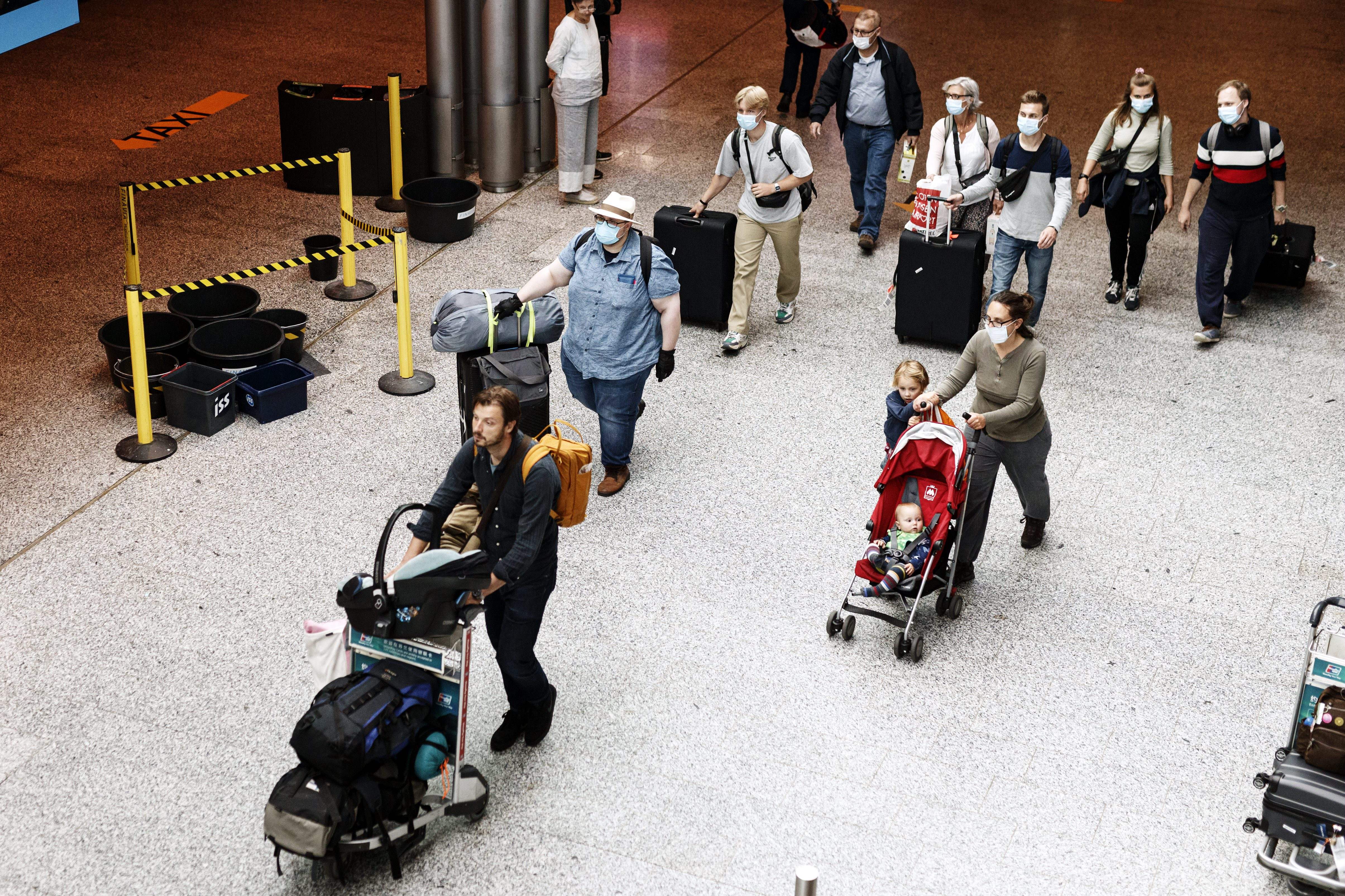 Passengers wear face masks at the Helsinki-Vantaa airport in Vantaa, Finland on July 13, 2020 as Finnish Government eased COVID-19 pandemic in and out travel restrictions with several EU countries. 