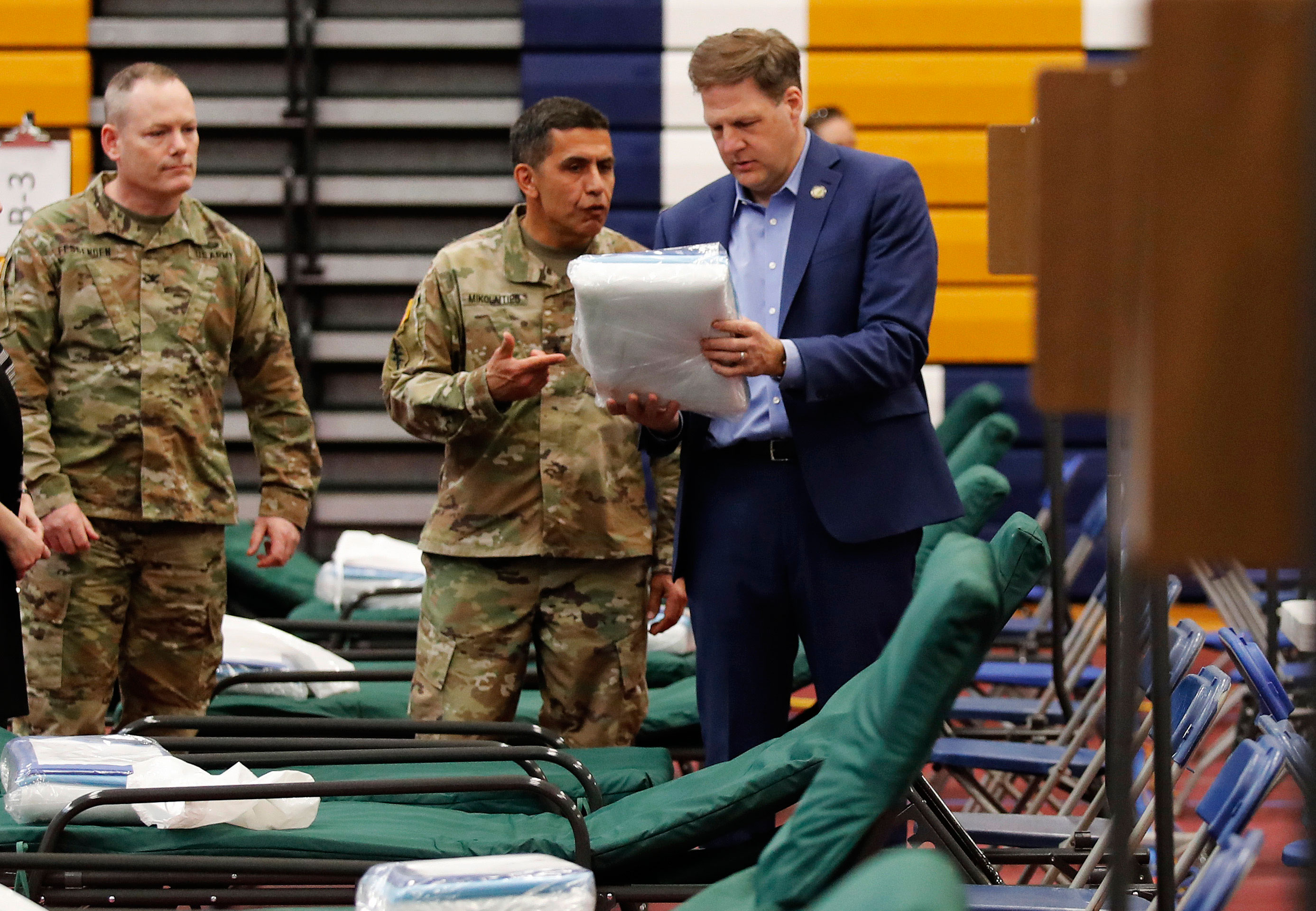 New Hampshire Gov. Chris Sununu, right, tours a makeshift medical facility at Southern New Hampshire University in Manchester, New Hampshire on March 24.