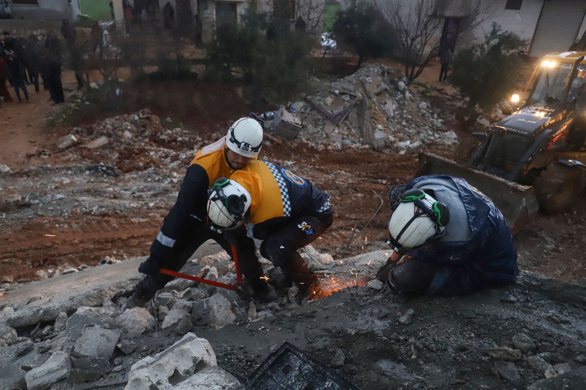 Members of the White Helmets search through rubble for survivors in the countryside of the northwestern Syrian Idlib province, early on Monday.
