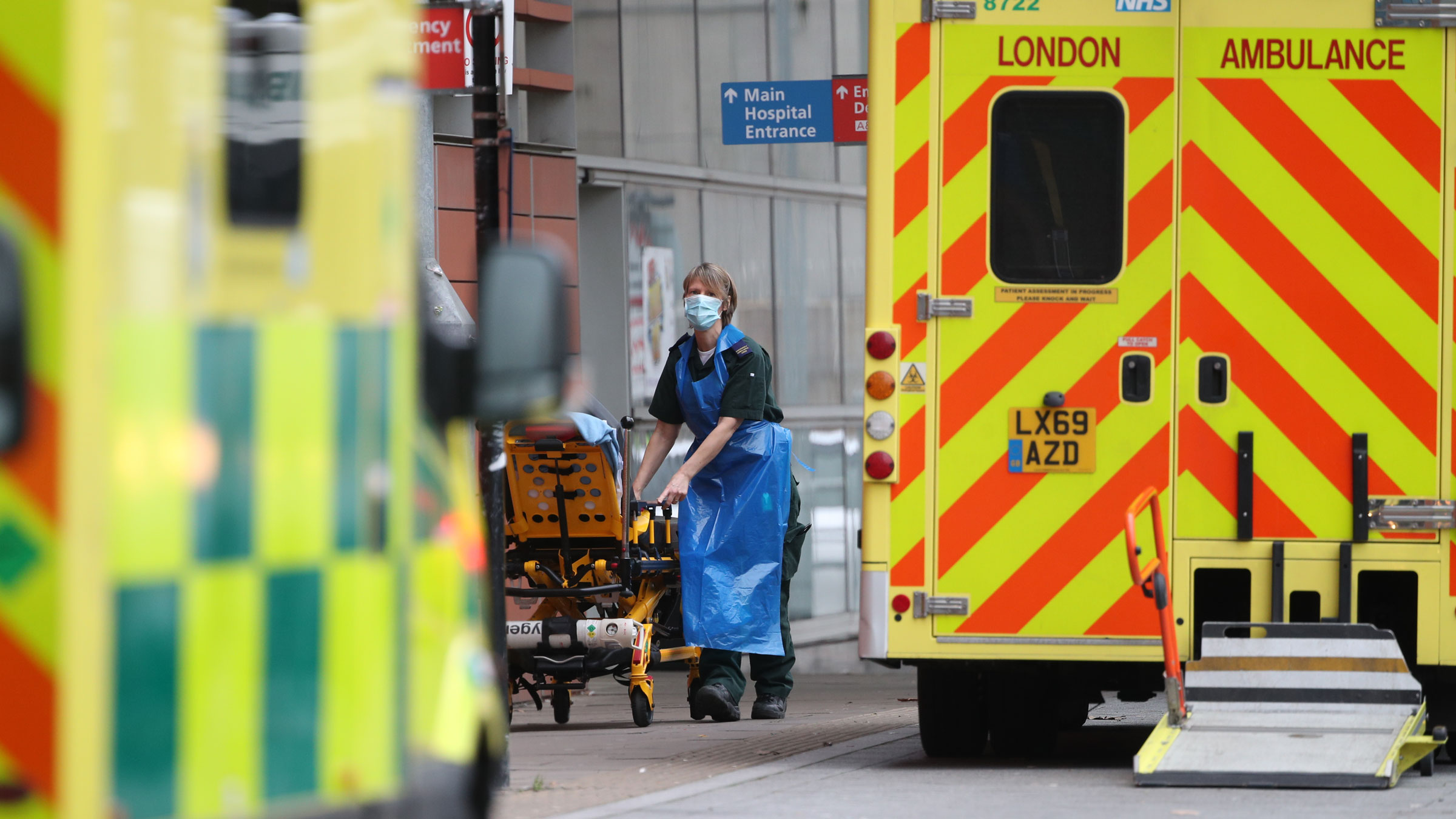 A paramedic wheels a gurney outside the Royal London Hospital on Thursday, January 21.