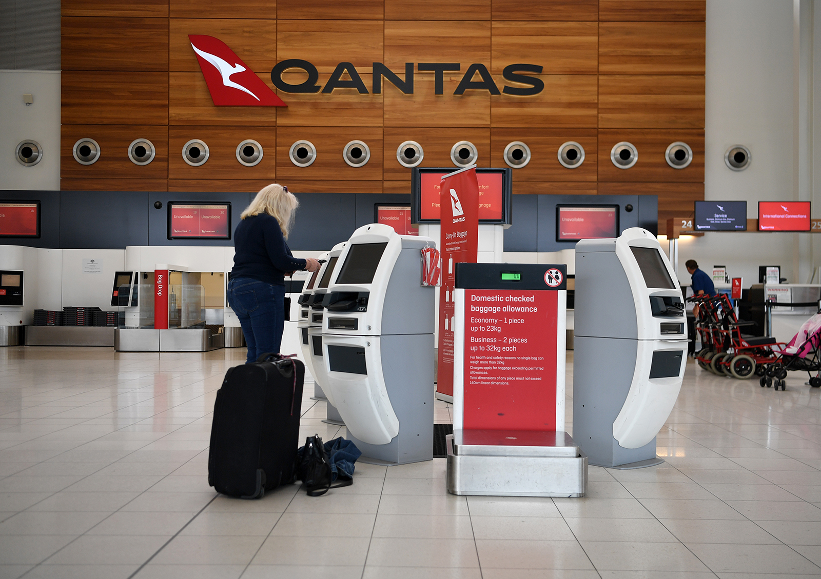 Passengers check in for a Qantas flight at Adelaide Airport on April 1, in Adelaide, Australia.