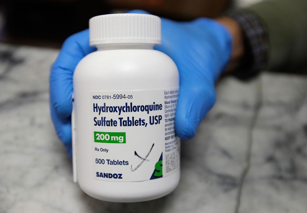A pharmacist shows a bottle of the drug hydroxychloroquine on Monday, April 6, in Oakland, California.
