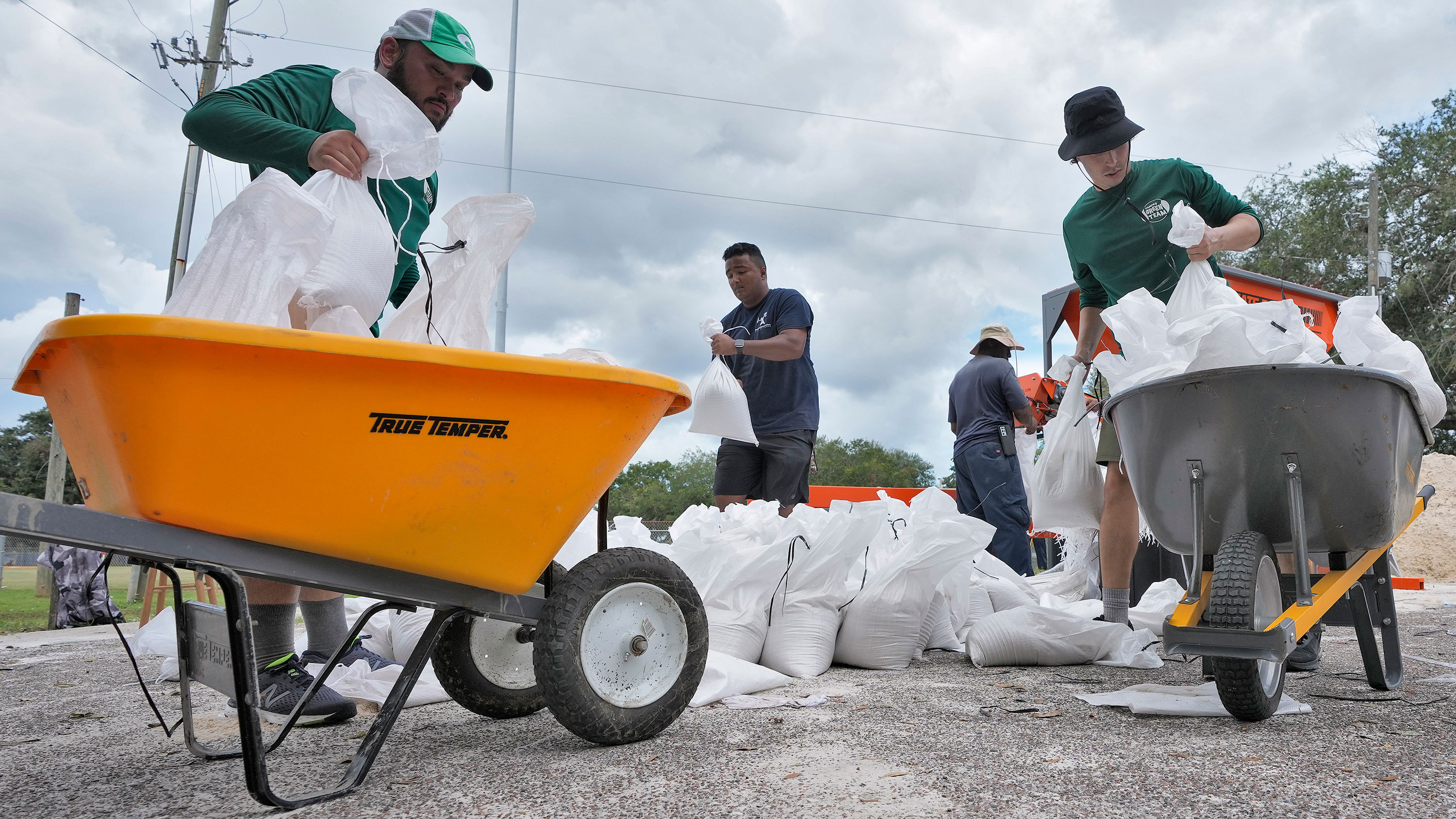Members of the Tampa Parks and Recreation Department help residents bag sand on Monday.