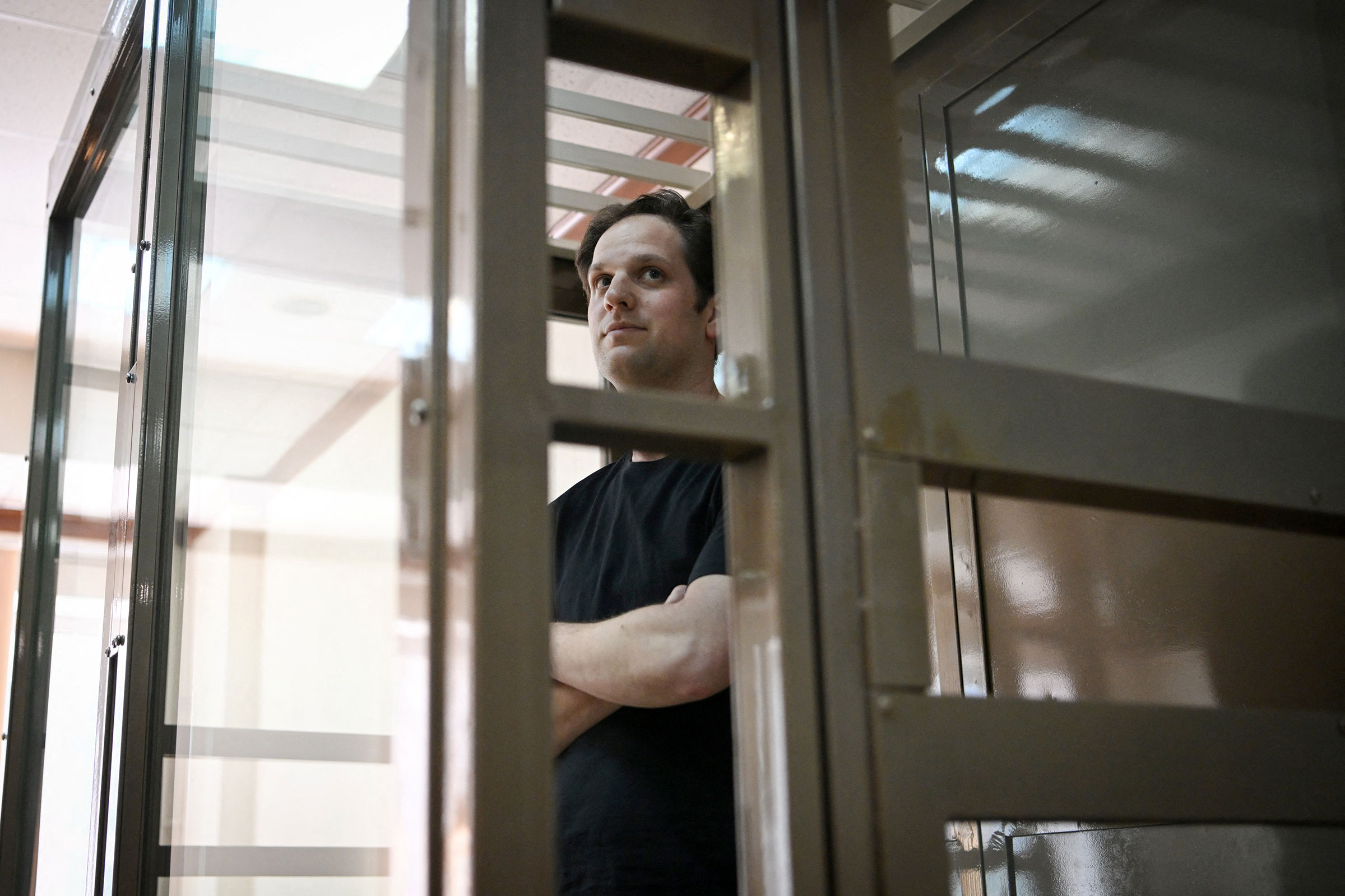 Journalist Evan Gershkovich, arrested on espionage charges, stands inside a defendants' cage before a hearing to consider an appeal on his extended detention at The Moscow City Court in Moscow on June 22.