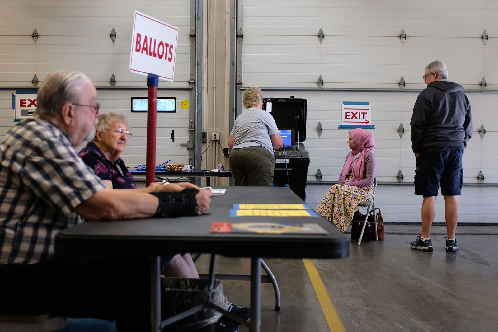 Poll workers and voters participate during the state primaries on August 9 at the Village Hall of Waukesha in Wisconsin.