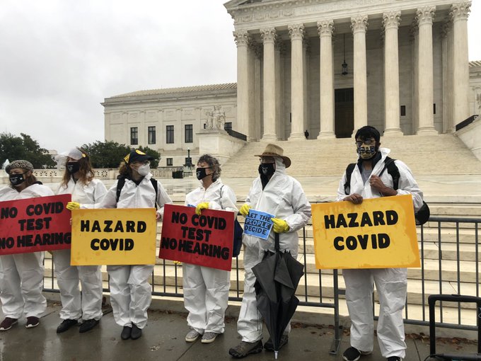 Organizers with Demand Justice protest outside the Supreme Court on Monday.