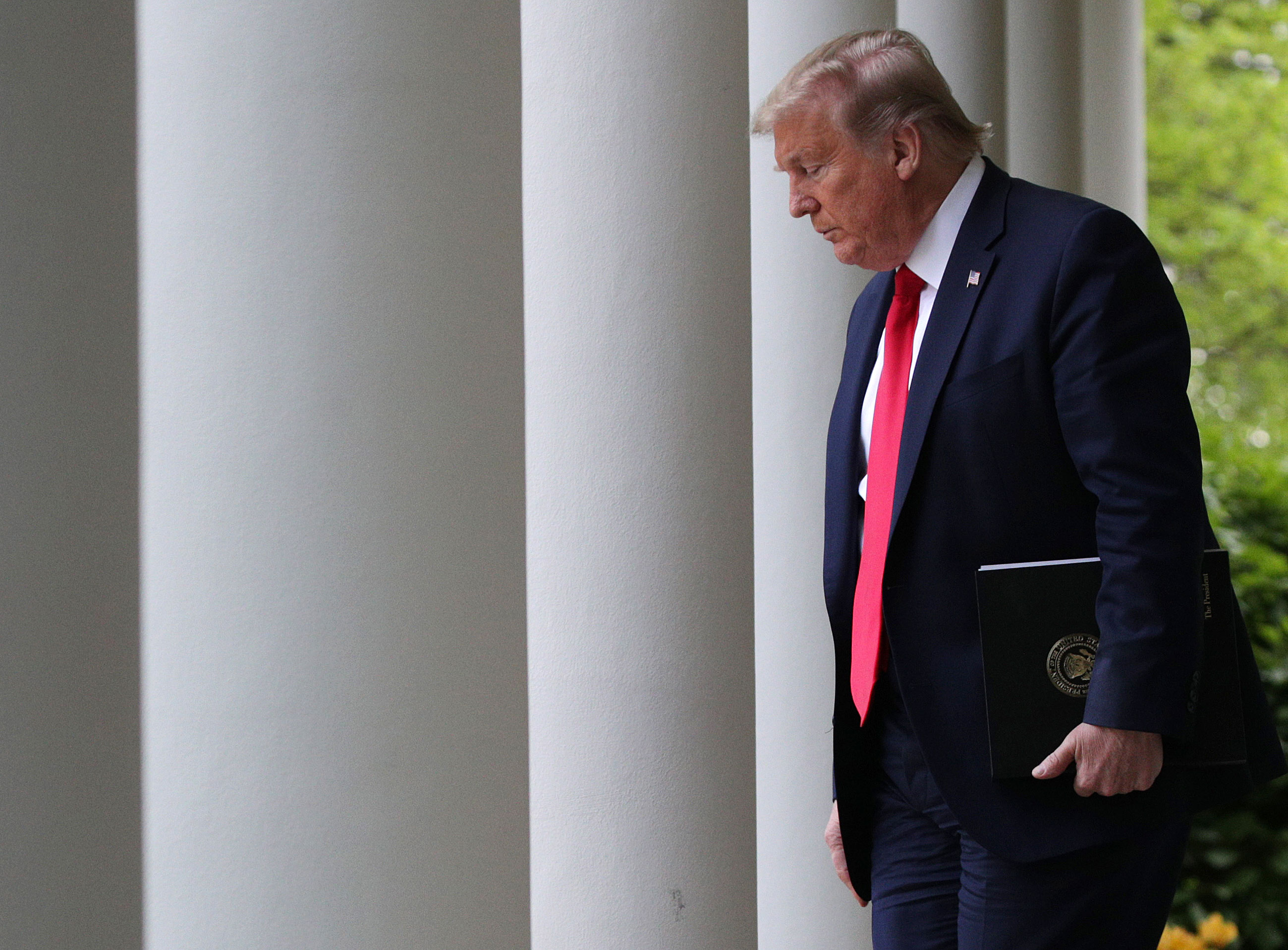 US President Donald Trump walks to the Rose Garden to attend the daily briefing of the White House Coronavirus Task Force, at the White House on April 14, in Washington.