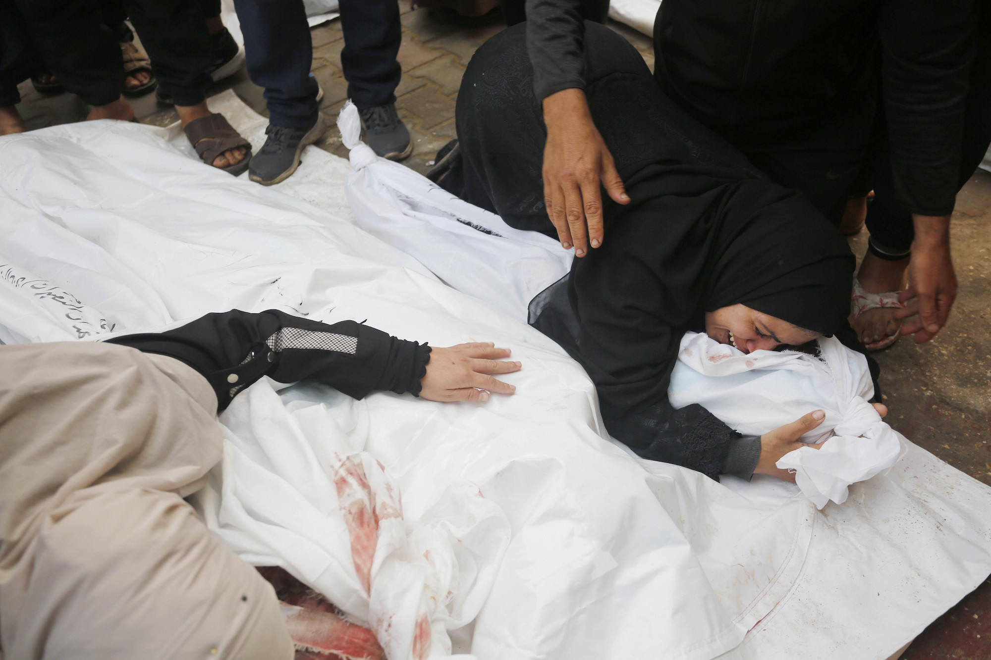 Relatives of dead Palestinians mourn at the Al-Aqsa Martyrs Hospital in Deir Al-Balah, Gaza, on Wednesday.