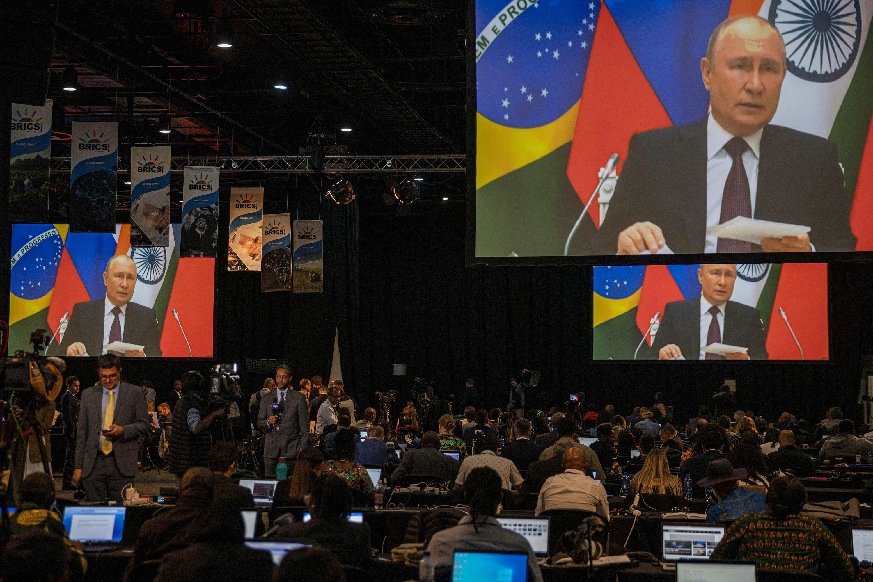 A screen in the media center shows Russian President Vladimir Putin delivering remarks via video-link during the 2023 BRICS Summit at the Sandton Convention Centre in Johannesburg, South Africa, on August 24, 2023.