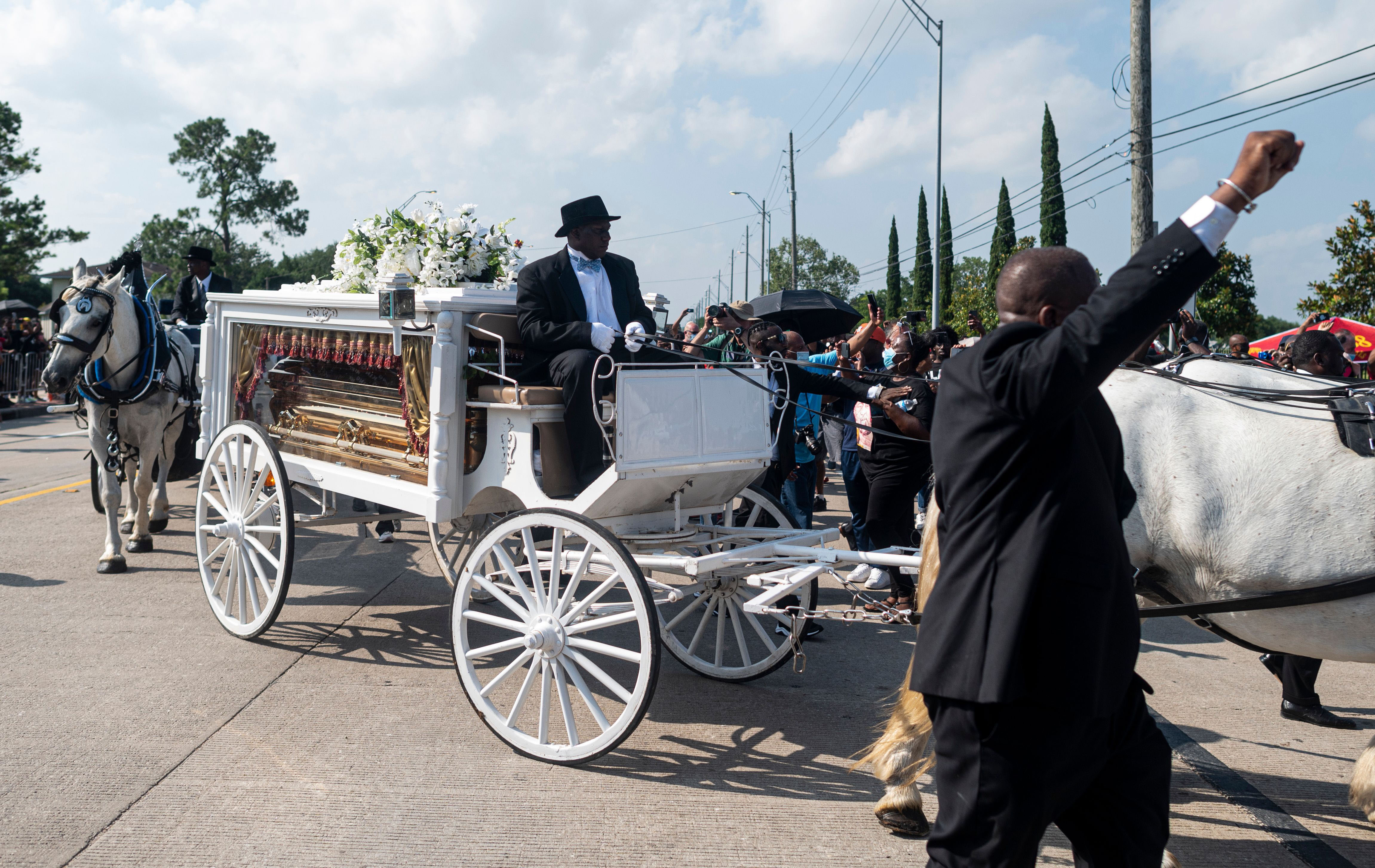 A horse-drawn carriage carries George Floyd's casket to Houston Memorial Gardens in Pearland, Texas, on June 9.