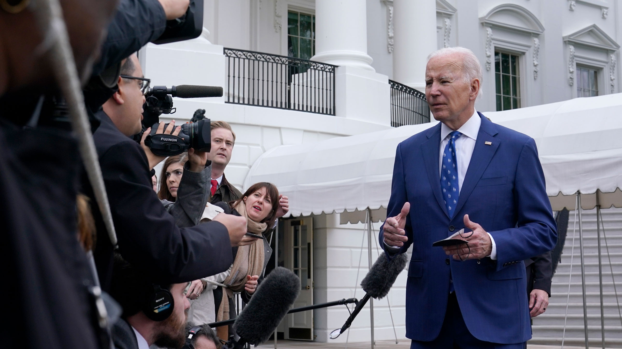 President Joe Biden meets with reporters before leaving for Kentucky on Wednesday.