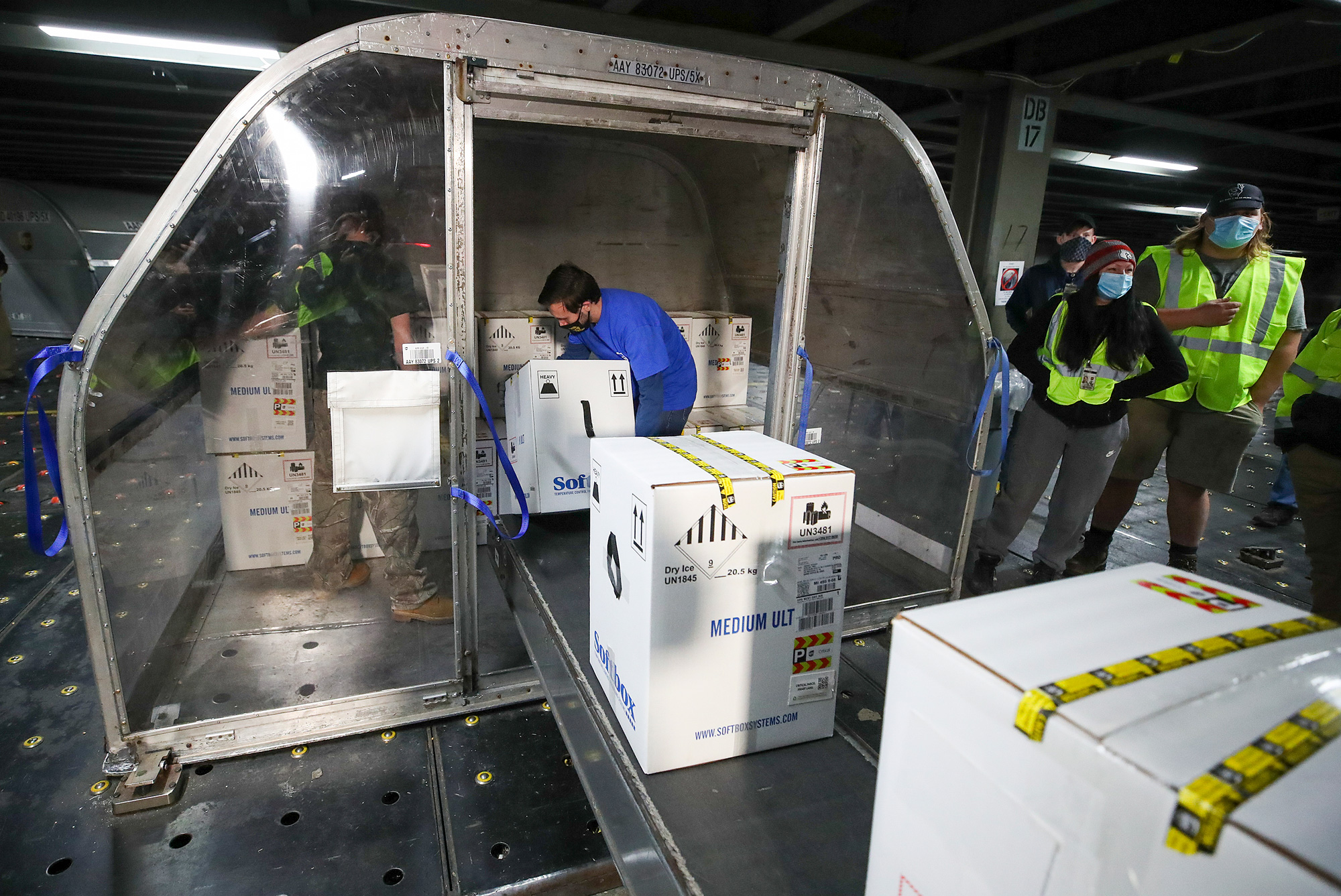 Boxes containing the first shipments of the Pfizer and BioNTech COVID-19 vaccine are unloaded from air shipping containers at UPS Worldport on December 13 in Louisville, Kentucky. 