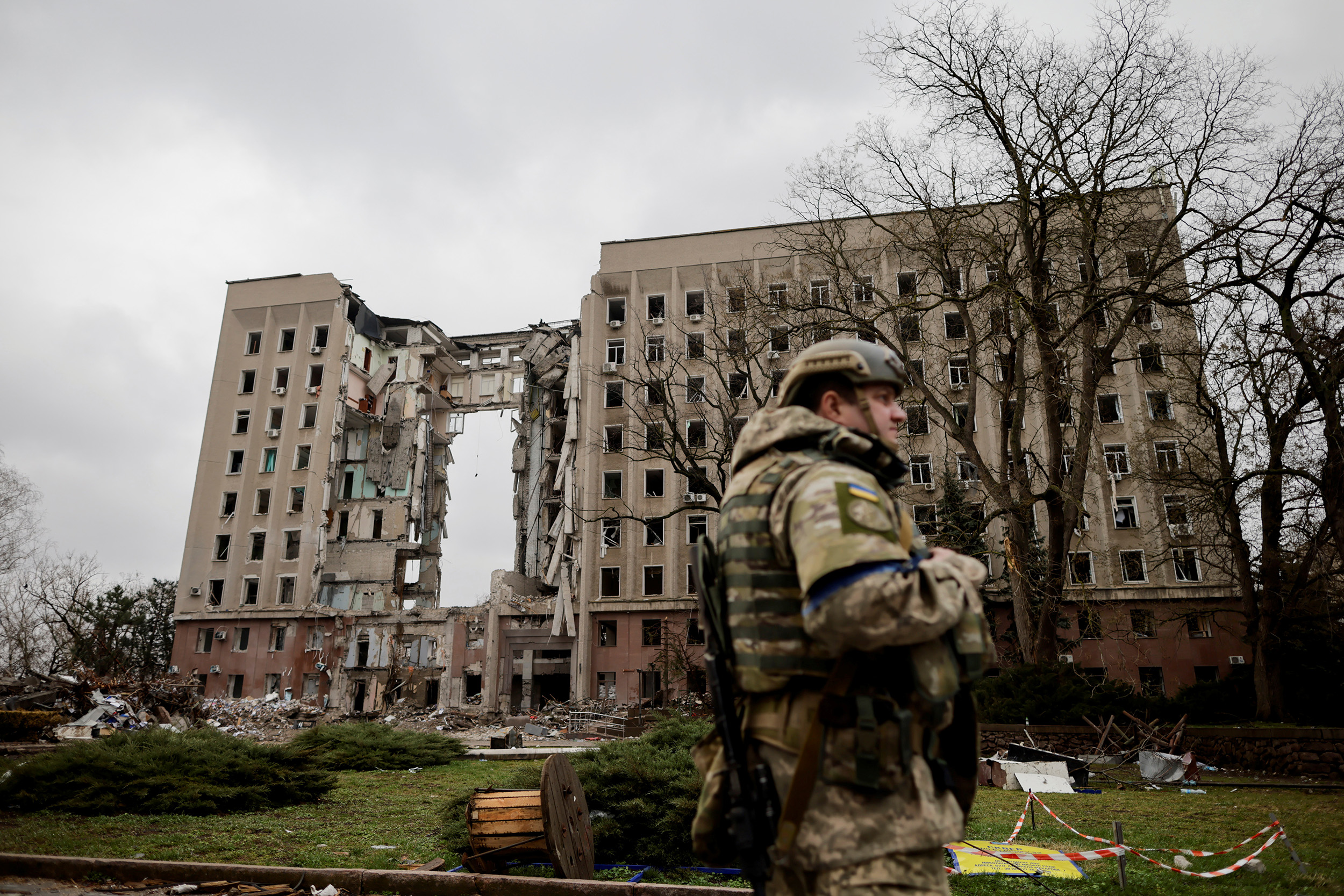 A soldier stands in front of a damaged Ukrainian government administration building following shelling in Mykolaiv, Ukraine, on April 8.