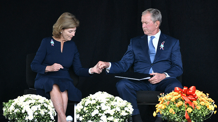 Former US President George W. Bush and former First Lady Laura Bush hold hands as they attend a 9/11 commemoration at the Flight 93 National Memorial in Shanksville, Pennsylvania on September 11, 2021. 