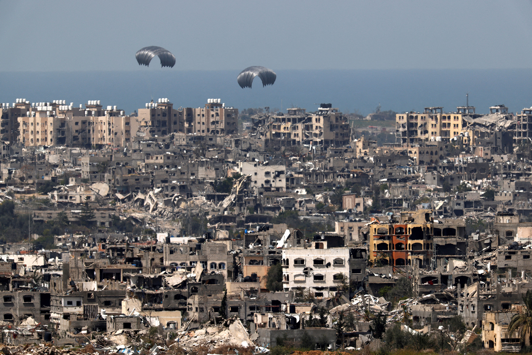 Humanitarian aid falls through the sky after being dropped from an aircraft in Gaza, on March 26. 