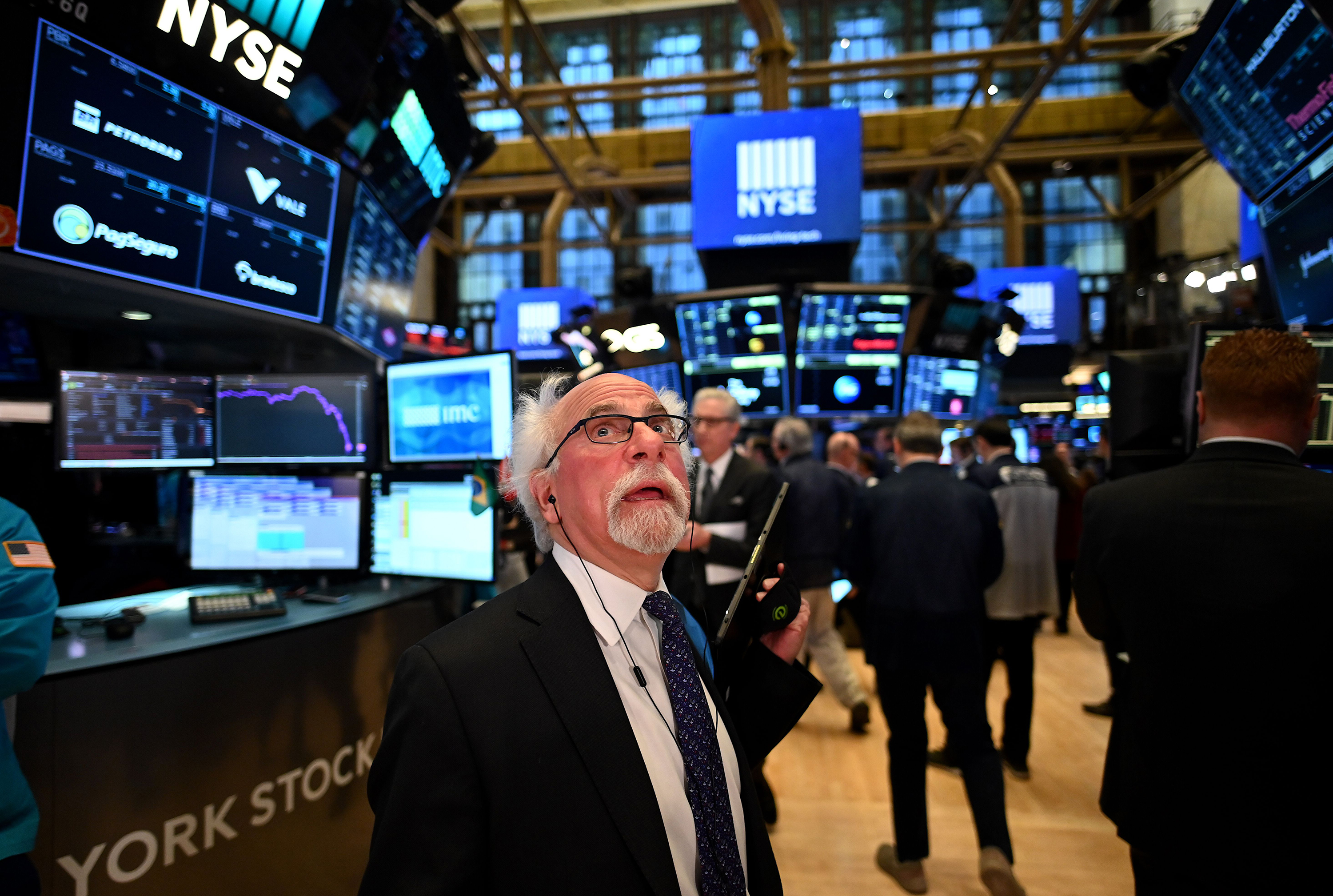 Traders work during the opening bell at the New York Stock Exchange (NYSE) on Monday, March 16.