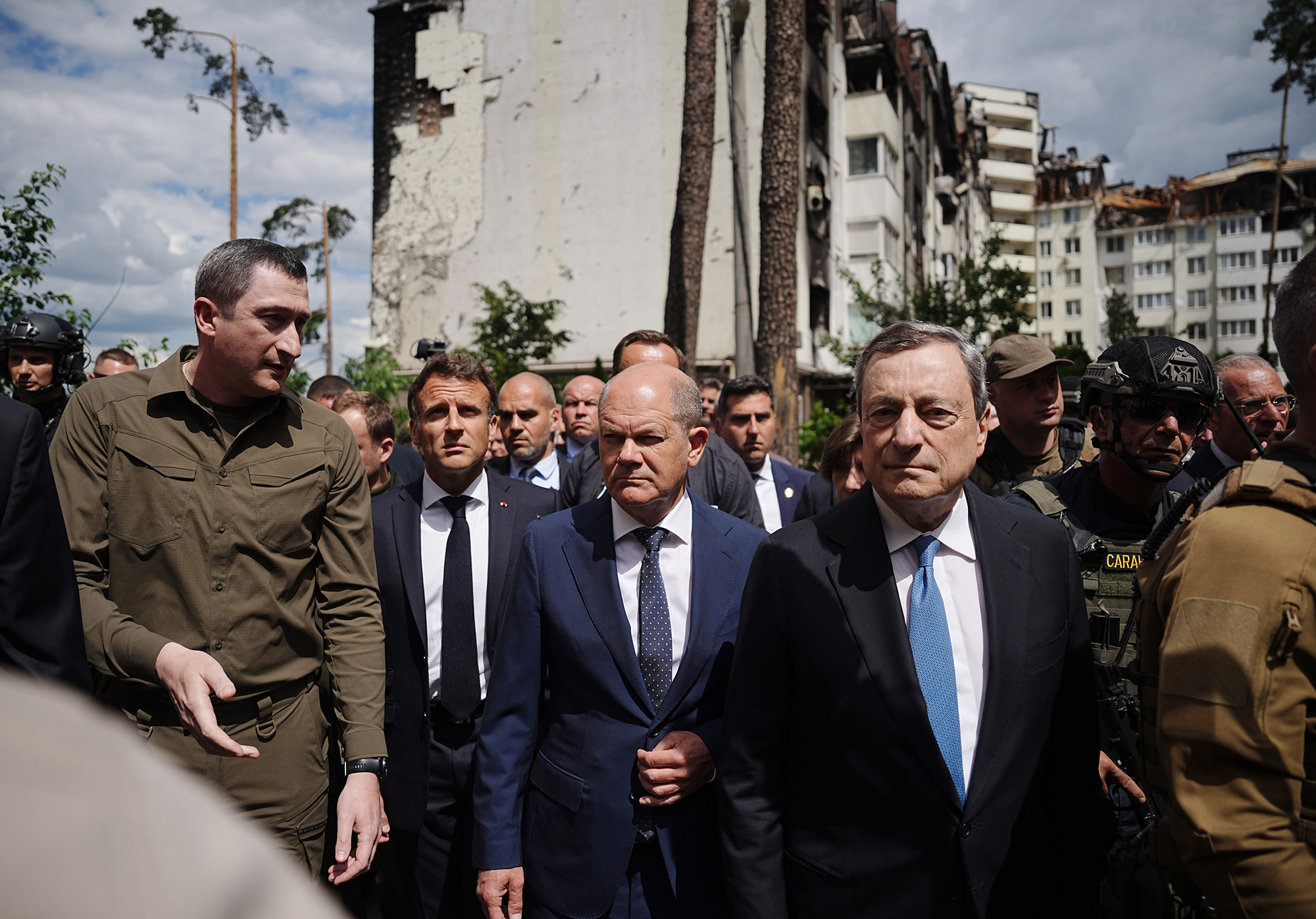 Oleksiy Chernyshov, Ukrainian President Zelensky's special envoy for EU accession, walks with French President Emmanuel Macron, German Chancellor Olaf Scholz and Italian PM Mario Draghi past destroyed buildings in Irpin, Ukraine, on June 16.