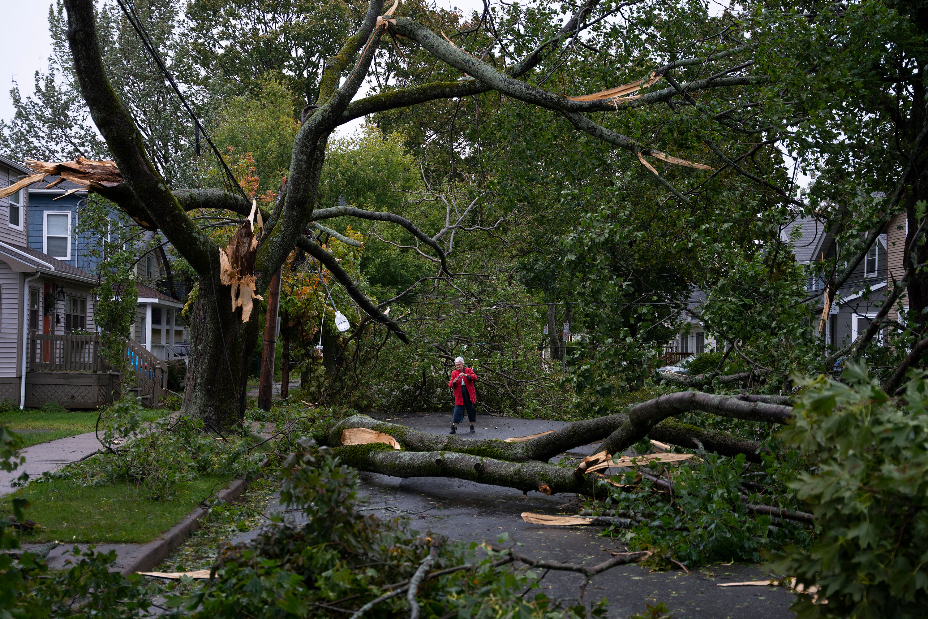 A resident surveys damage on her street in Halifax on September 24. 