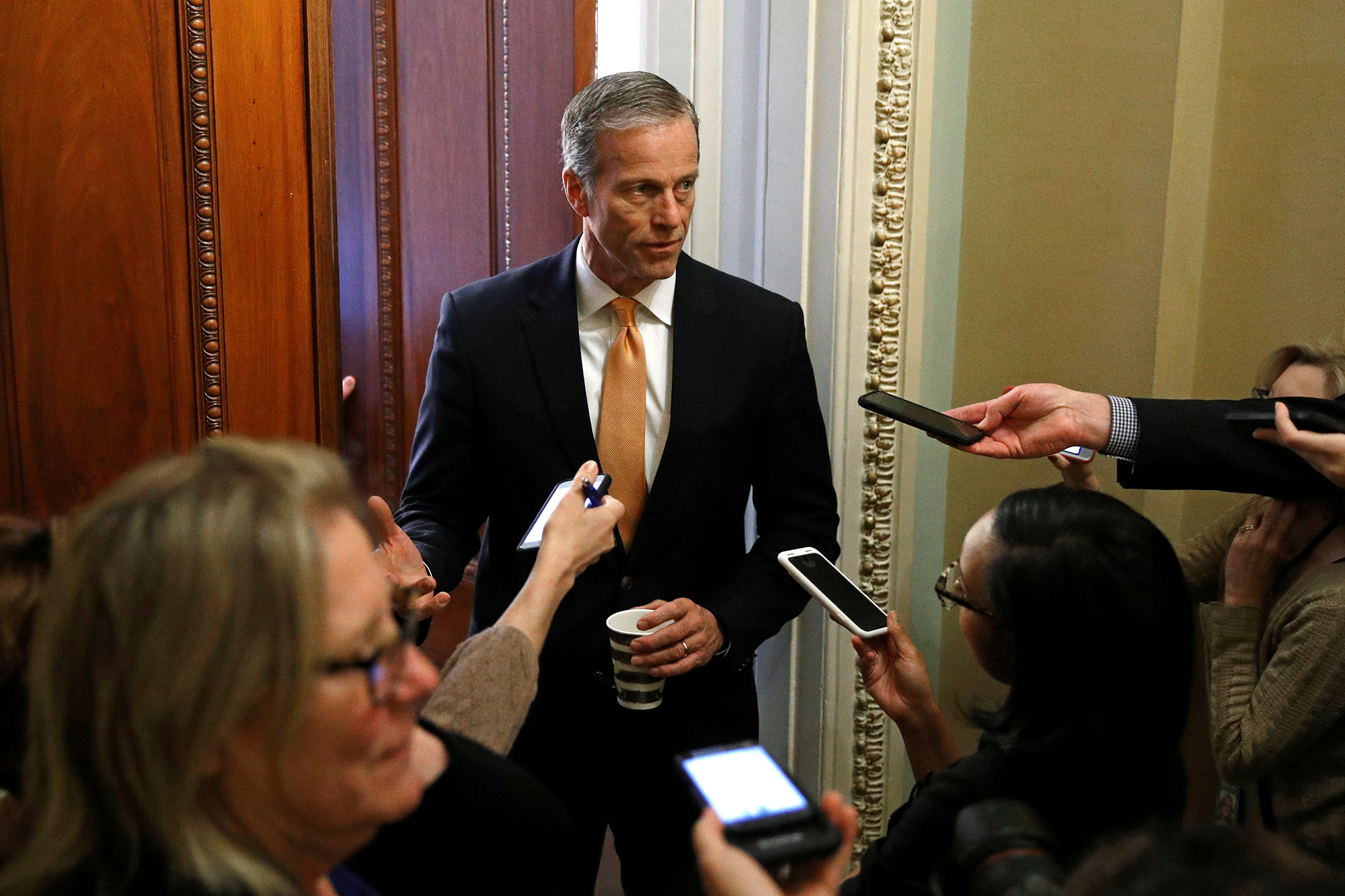 Senate Majority Whip John Thune speaks with reporters at the door to his office on Capitol Hill in Washington, Monday, March 16.