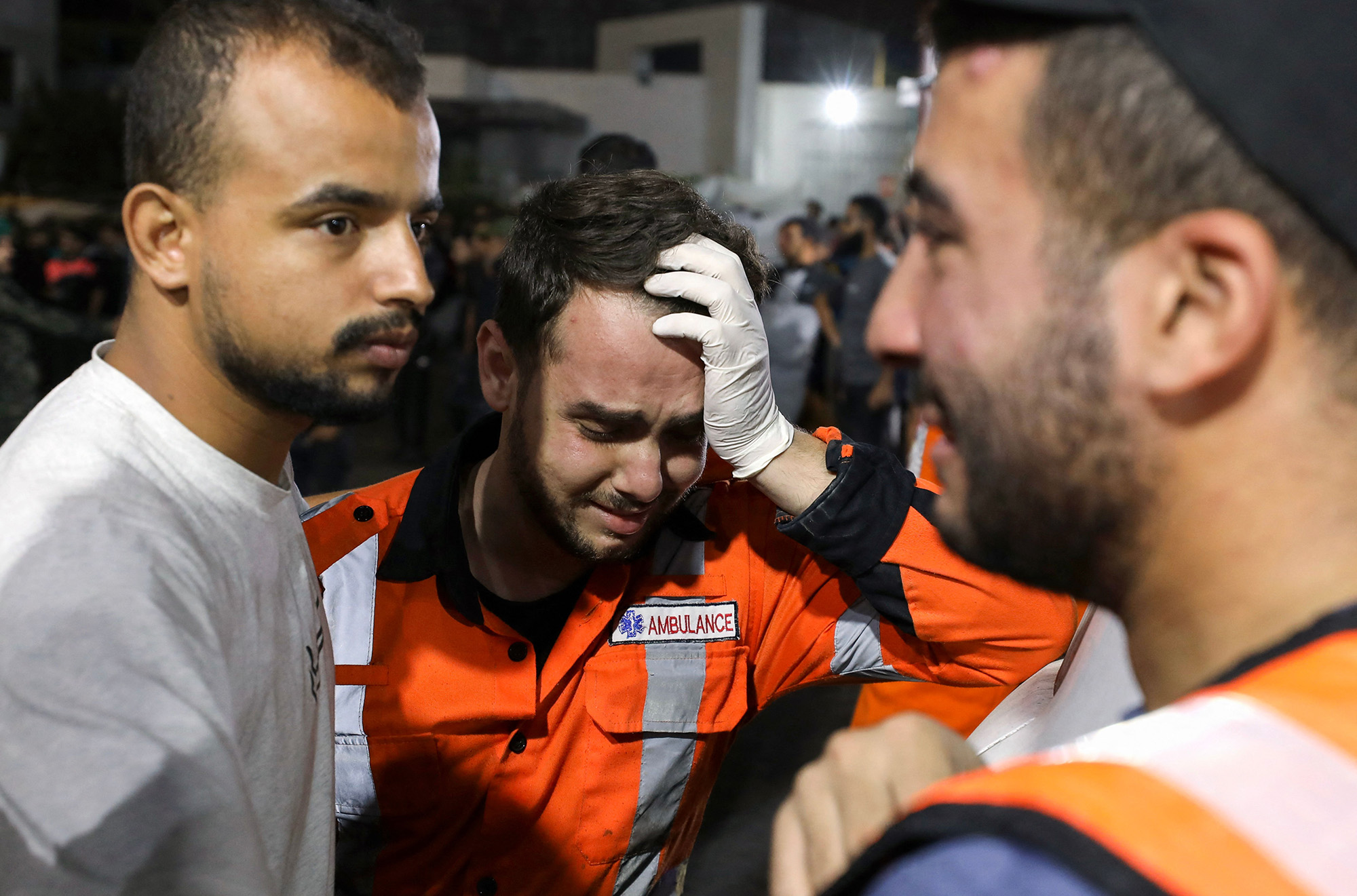 Palestinian paramedics cry outside Al-Shifa hopsital in Gaza City on October 16.
