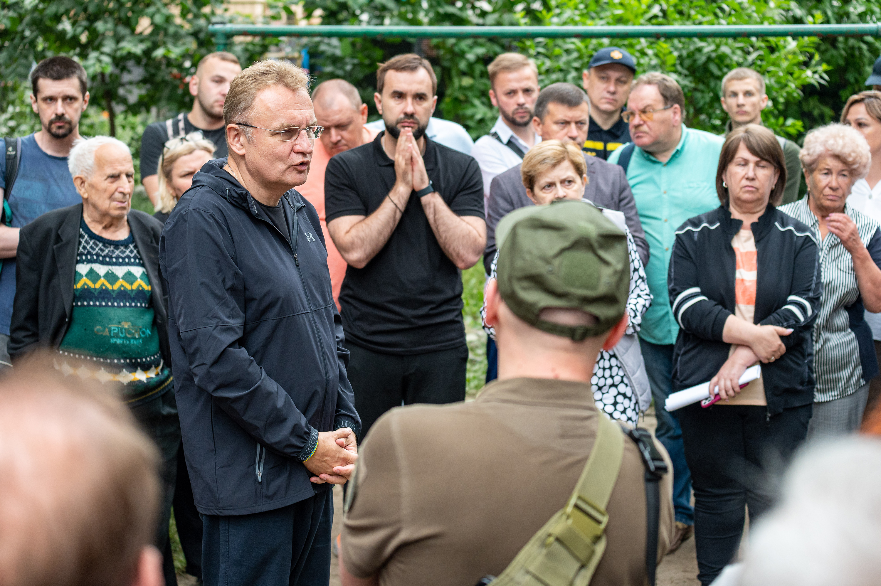 Lviv mayor Andriy Sadovyi (C), talks with residents of a four-story residential building hit by a missile on July 6 in Lviv, Ukraine.