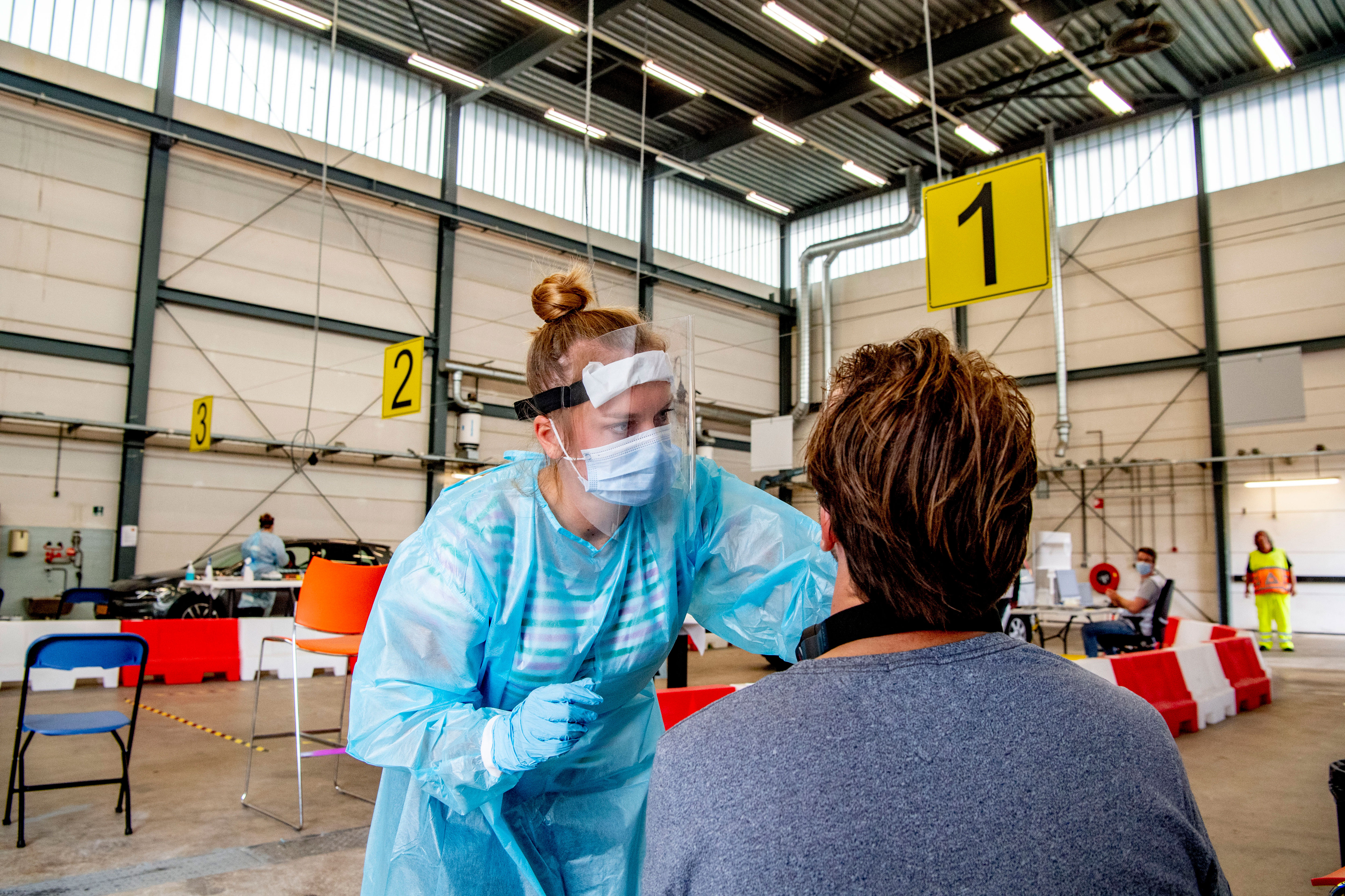 A health worker in Utrecht, Netherlands, tests someone for Covid-19 on August 31.