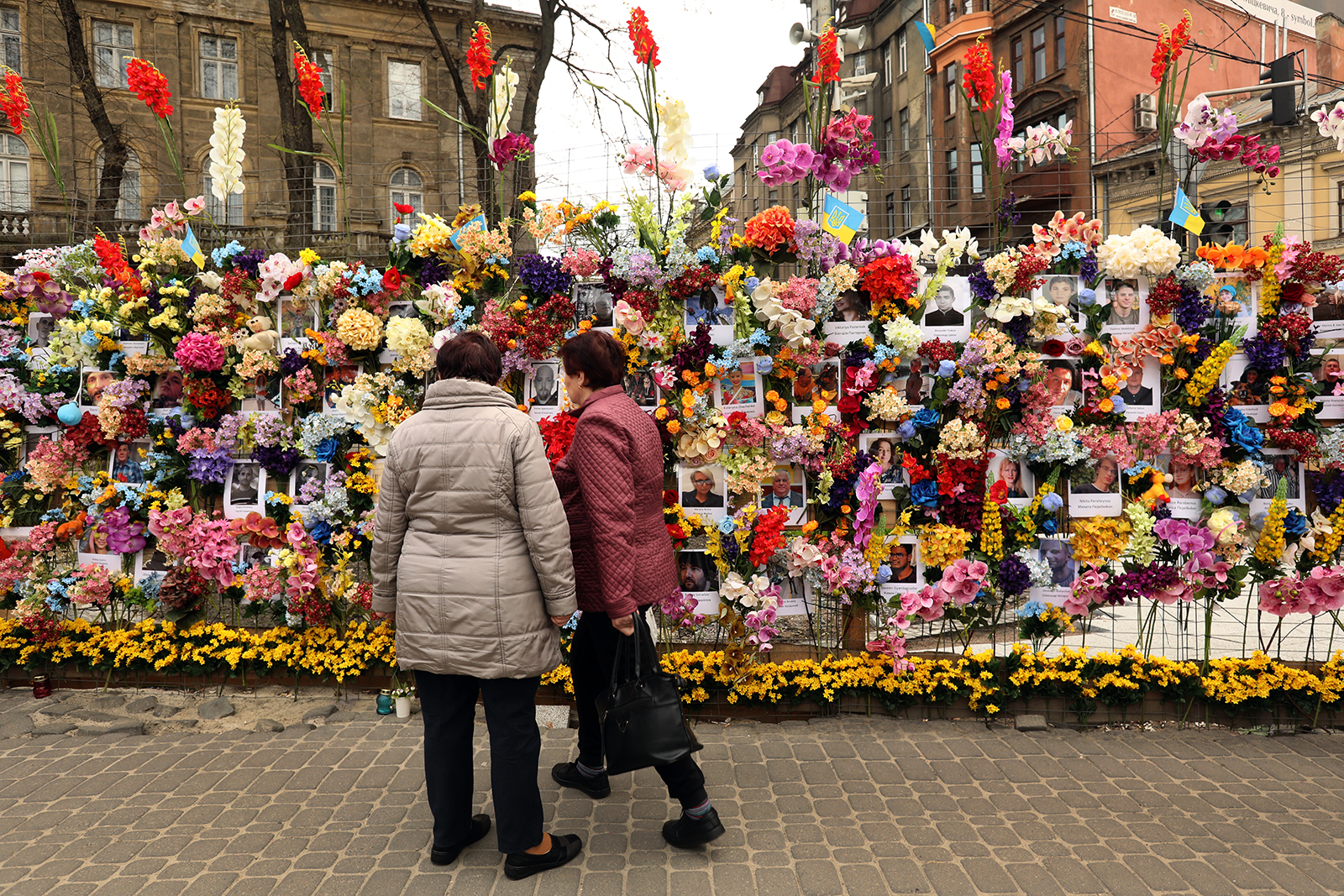 A memorial to those who have lost their lives in the Russian war on Ukraine is visited by people in downtown Lviv on Saturday, April 30.