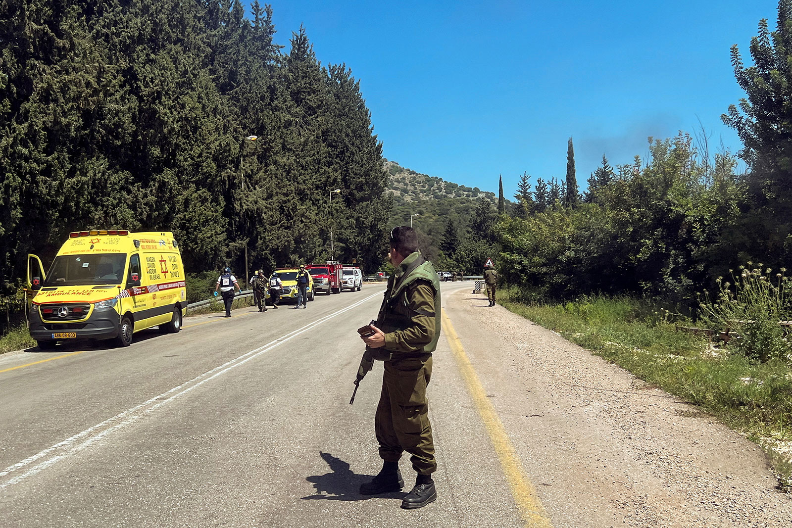 An Israeli soldier looks on at a scene, after it was reported that people were injured, near Arab al-Aramashe in northern Israel on Wednesday.