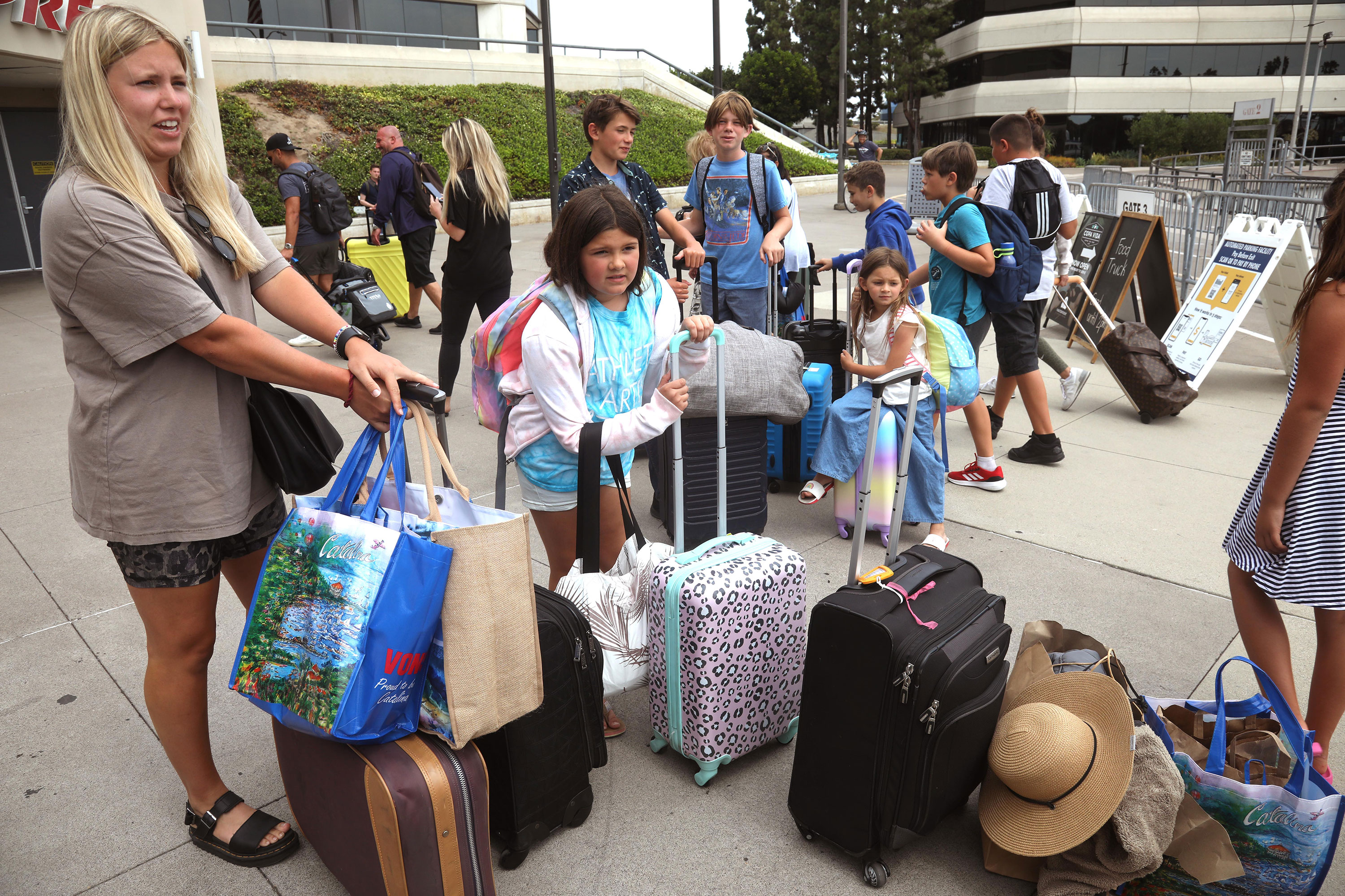 Families evacuating from Catalina Island arrive in Long Beach, California, on Saturday, August 19. 