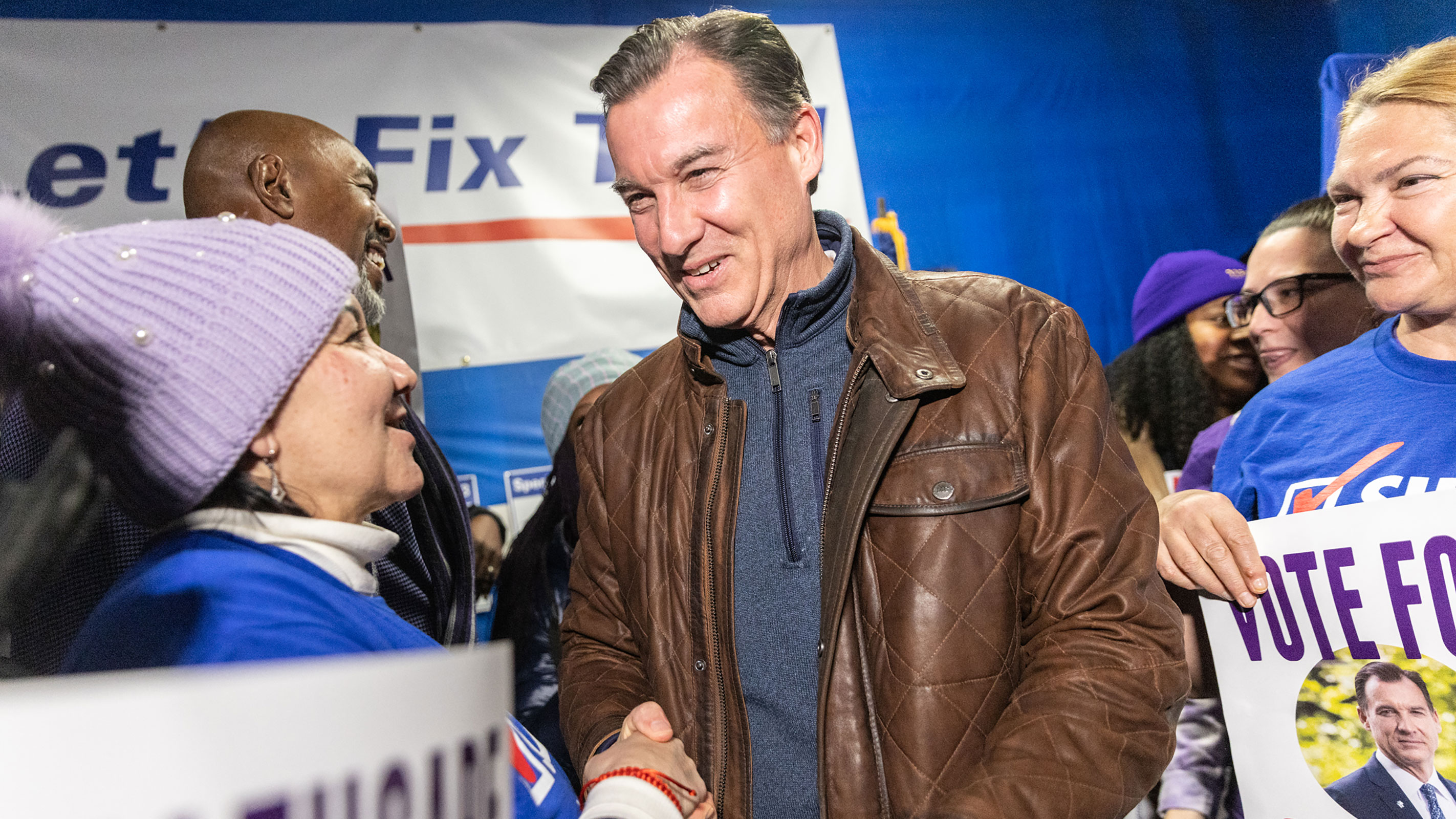 Tom Suozzi shakes hands with an attendee during the Westbury Canvass Launch in Westbury, New York, on Tuesday.