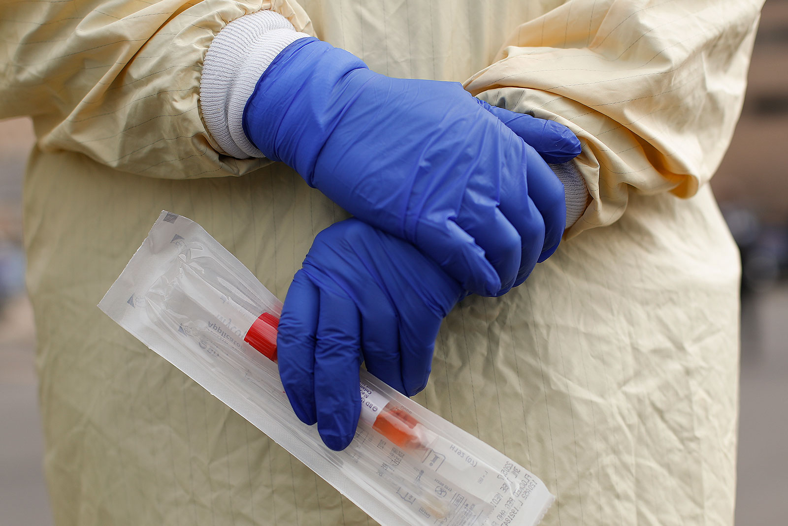 A nurse holds a coronavirus test kit at a drive-through test station in Royal Oak, Michigan, on Monday, March 16.