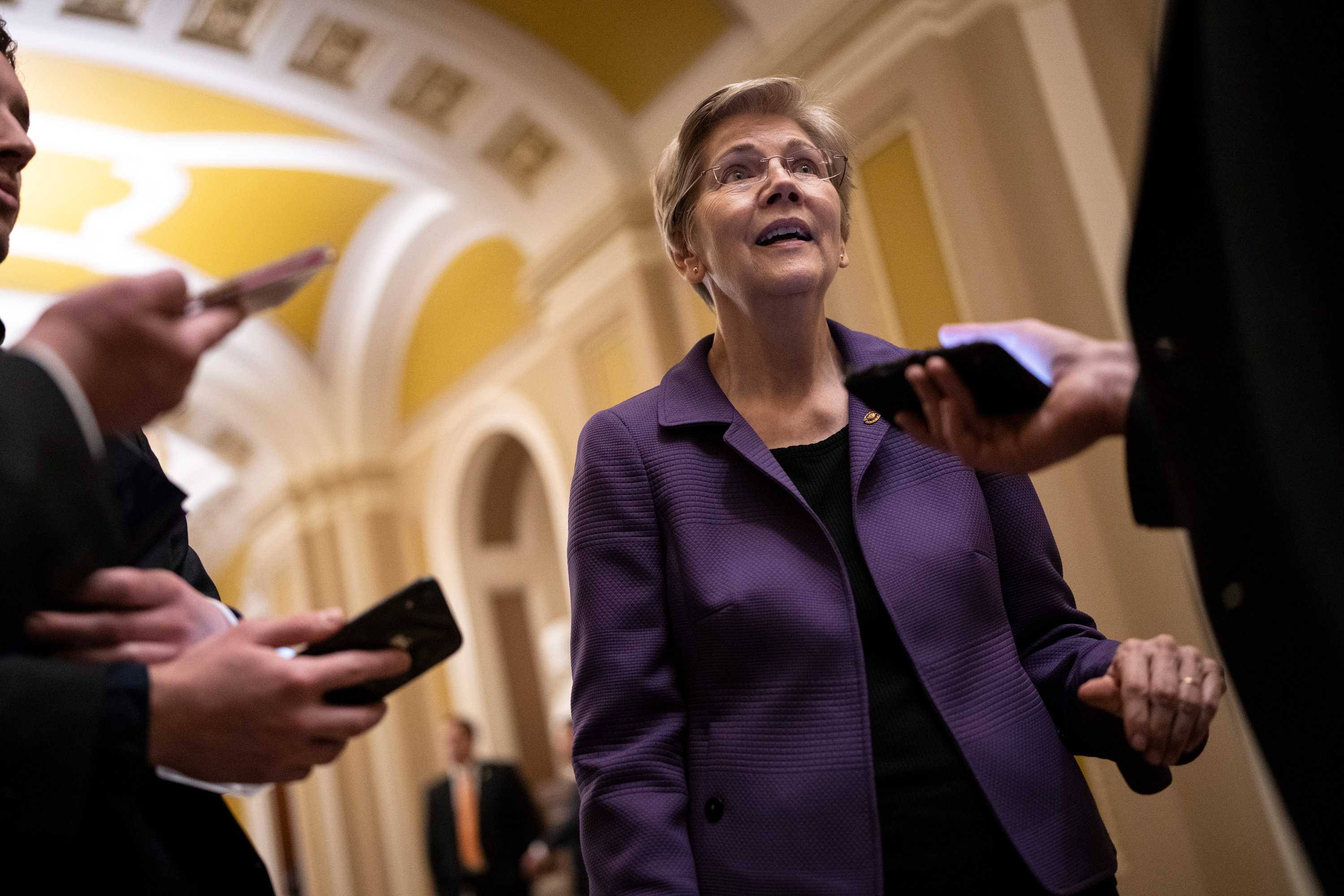 Senator Elizabeth Warren speaks with reporters on her way to a closed-door lunch meeting with Senate Democrats at the Capitol in Washington, DC on Wednesday. 