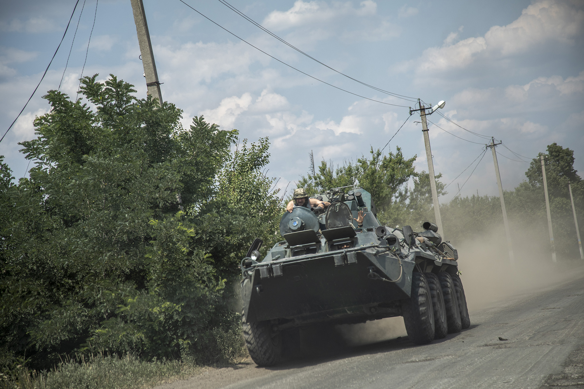 Ukrainian servicemen are seen riding on top of an armored personnel carrier in the Donetsk region, Ukraine, on July 5.