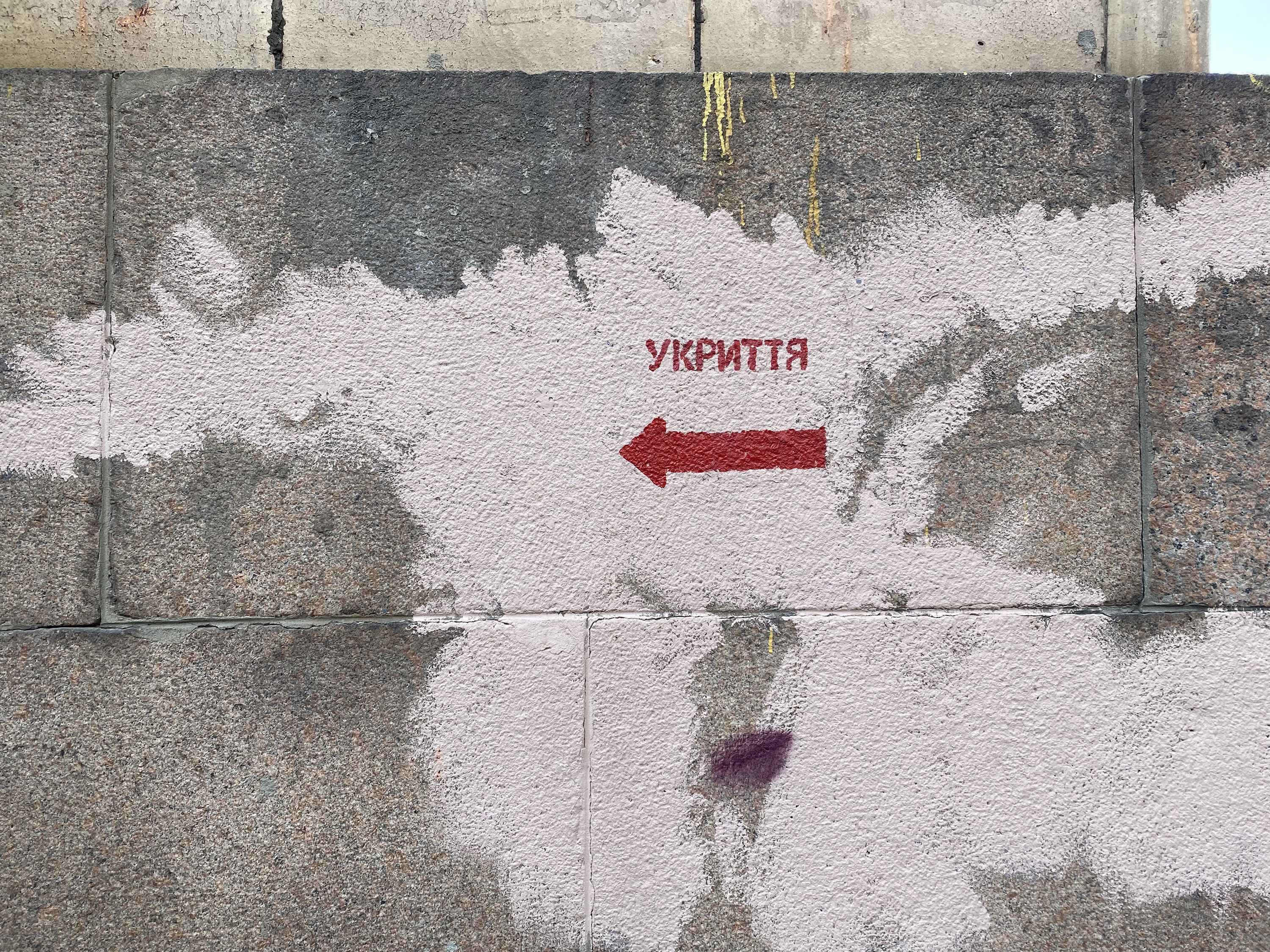 Across Kyiv, red arrows painted on walls indicate the locations of the nearest bomb shelters. The city first put them up after war broke out in eastern Ukraine in 2014, but they were recently repainted.