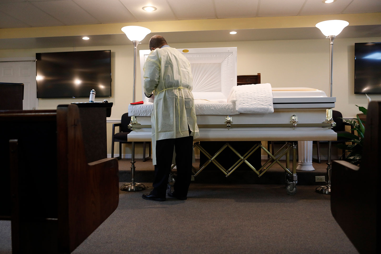 Funeral home director Jeffrey Rhodes prepares the body of man who died from coronavirus in Tampa, Florida.