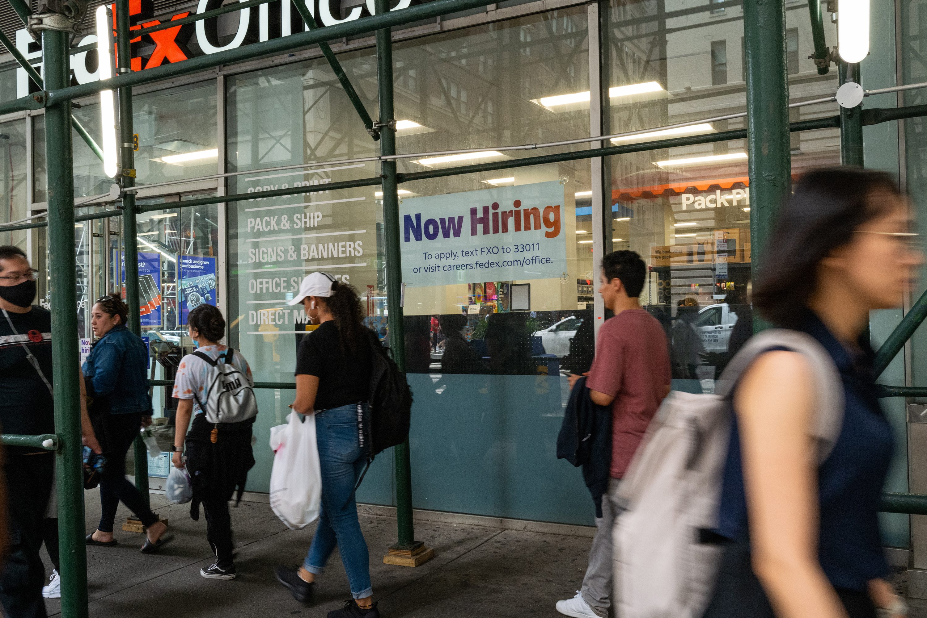 A "now hiring" sign is displayed in a window in Manhattan on July 28 in New York City.