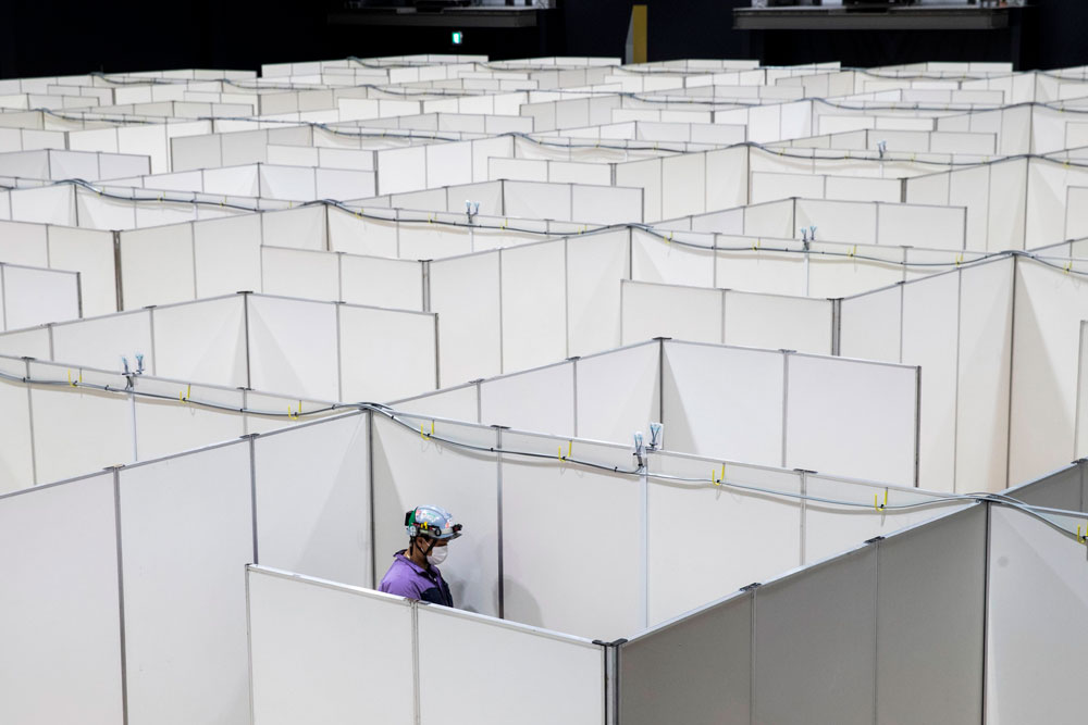 An employee helps set up a medical facility to accommodate coronavirus patients at the Nippon Foundation Para Arena in Tokyo on May 4.