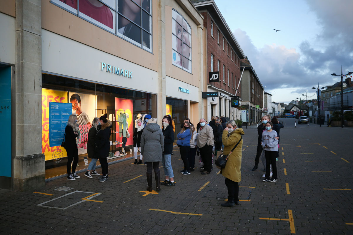 People line up to enter Primark as it opens for the first time since lockdown restrictions were last introduced on April 12, 2021 in Truro, England.