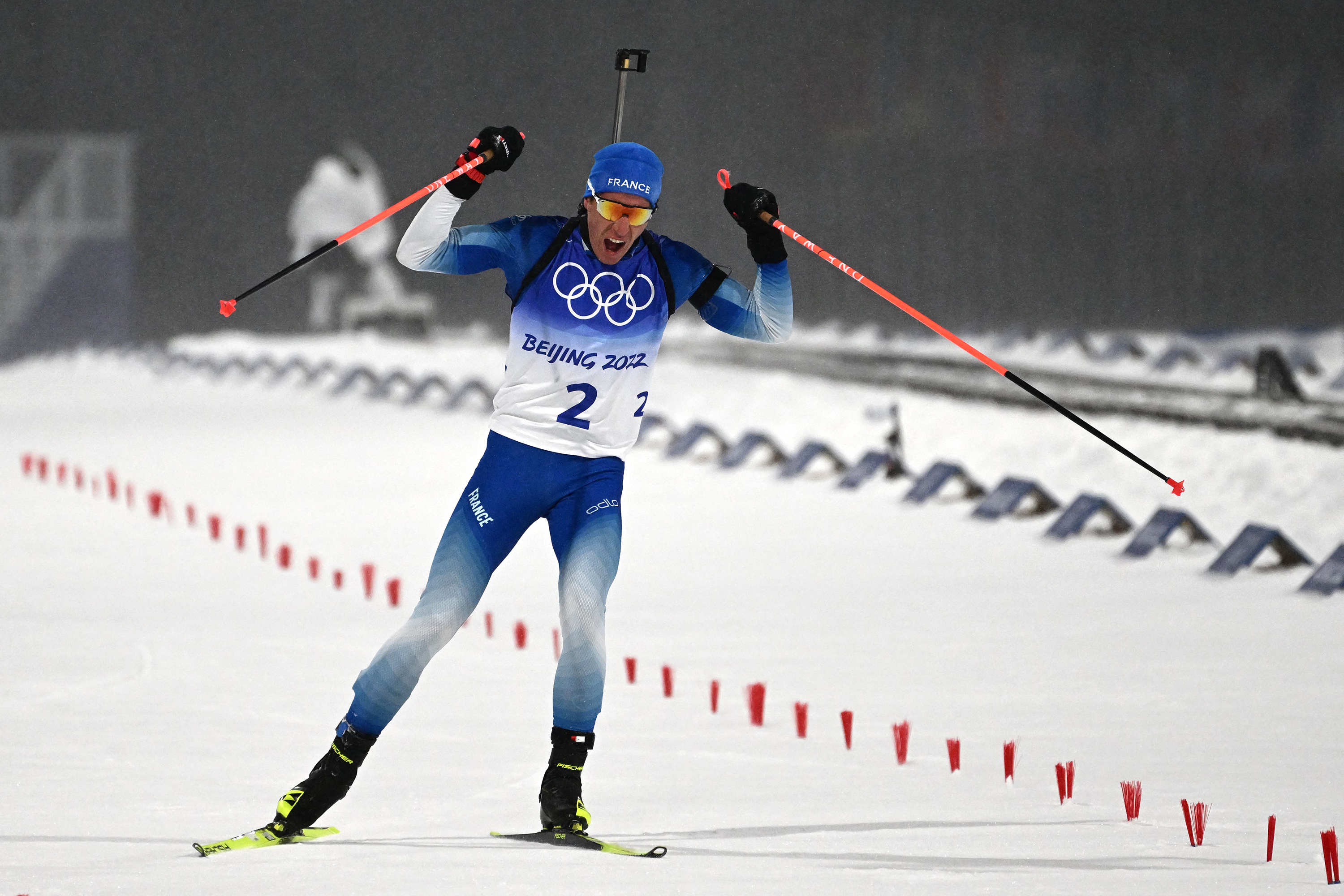 France's Quentin Fillon Maillet celebrates as he wins the biathlon men's 12.5km pursuit event on February 13. 