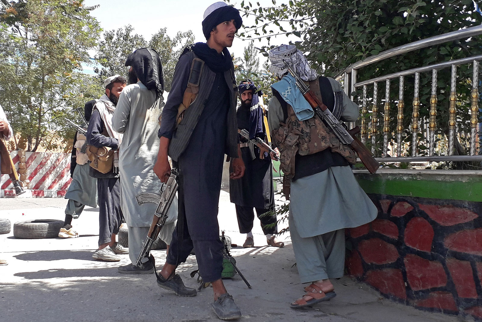 Taliban fighters stand along a road in Ghazni, Afghanistan, on Thursday, August 12.