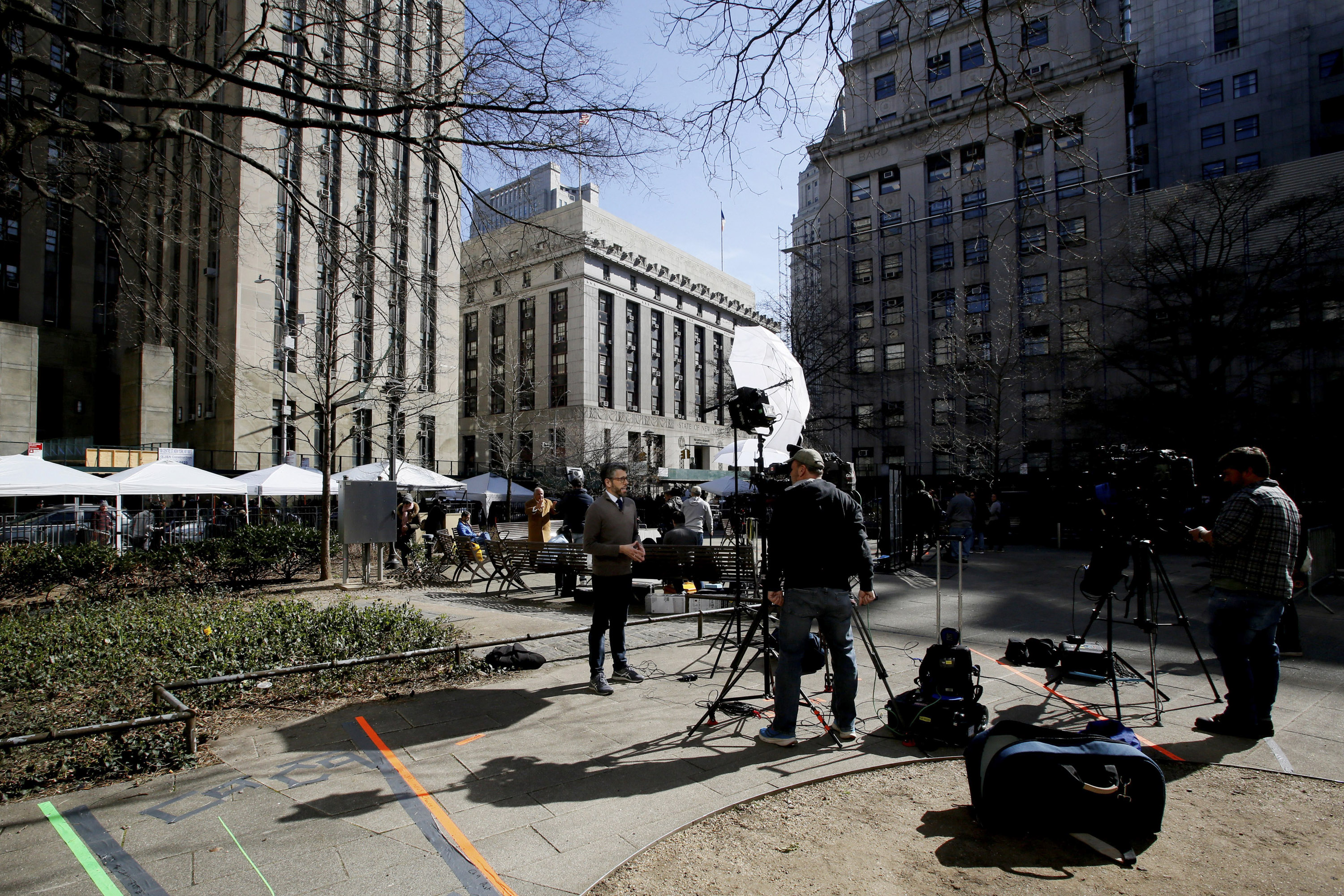Members of the media stand outside the Manhattan District Attorney's office in New York City on Monday, April 3. 