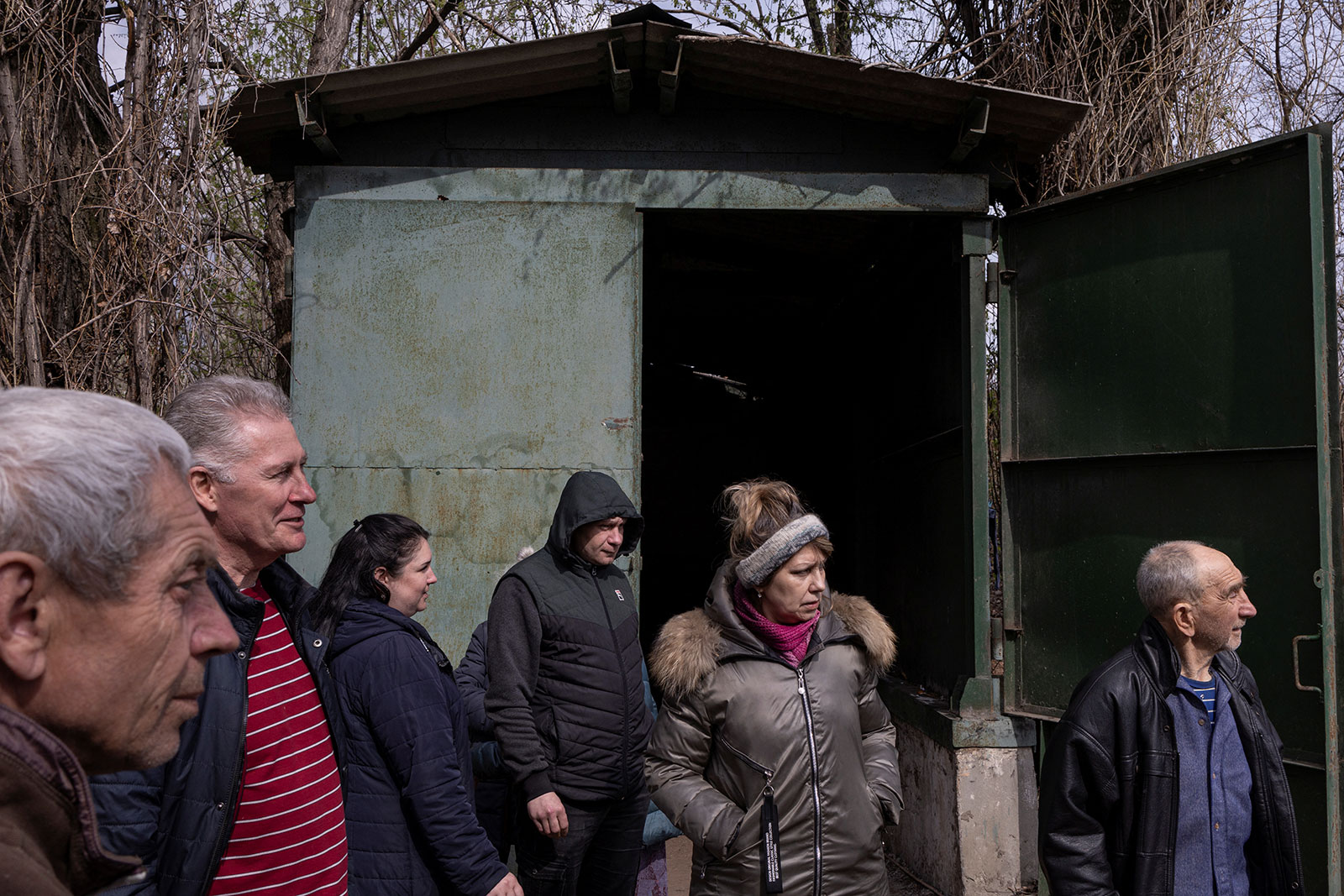 People stand in front of the entrance of a bomb shelter, where they have been hiding from shelling since the beginning of the war, in the Luhansk region of Severodonetsk on Saturday, April 16. 