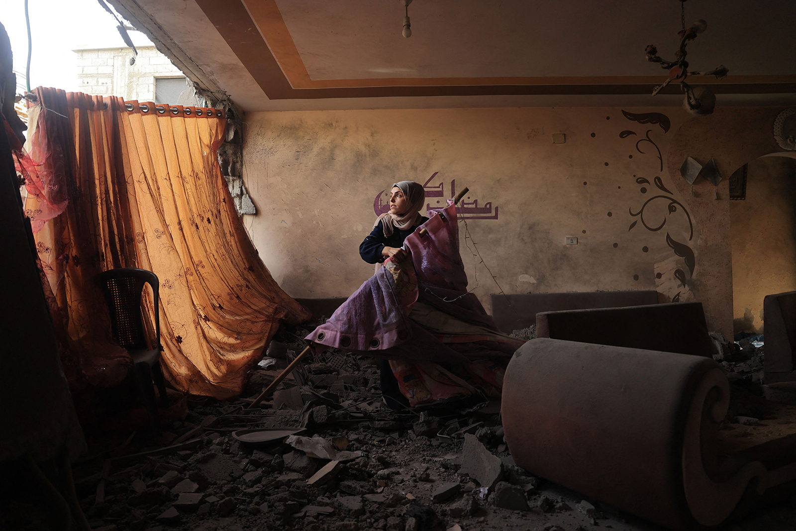 A relative tries to salvage items from a destroyed home in Rafah, Gaza, on November 19. 
