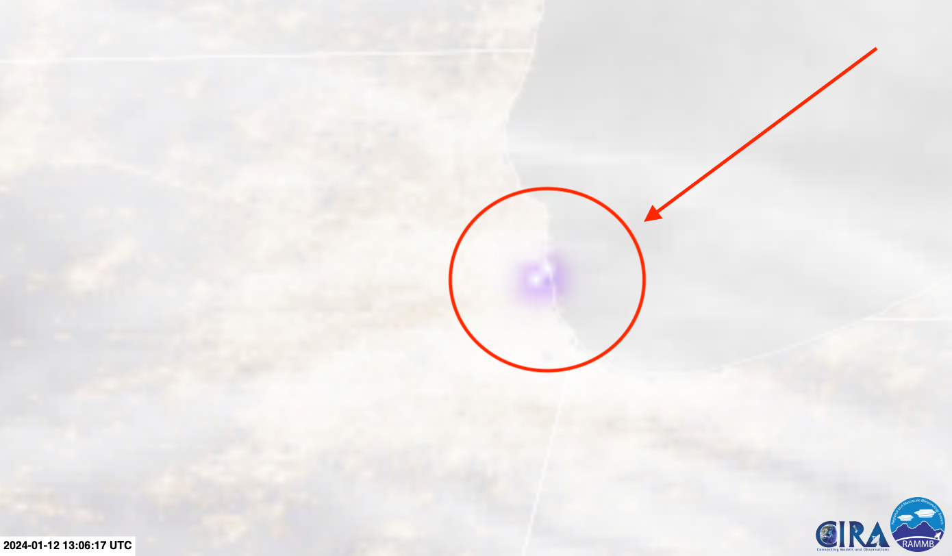 Still image of lightning (white dots with purple outlines) within snow over Chicago Friday morning.