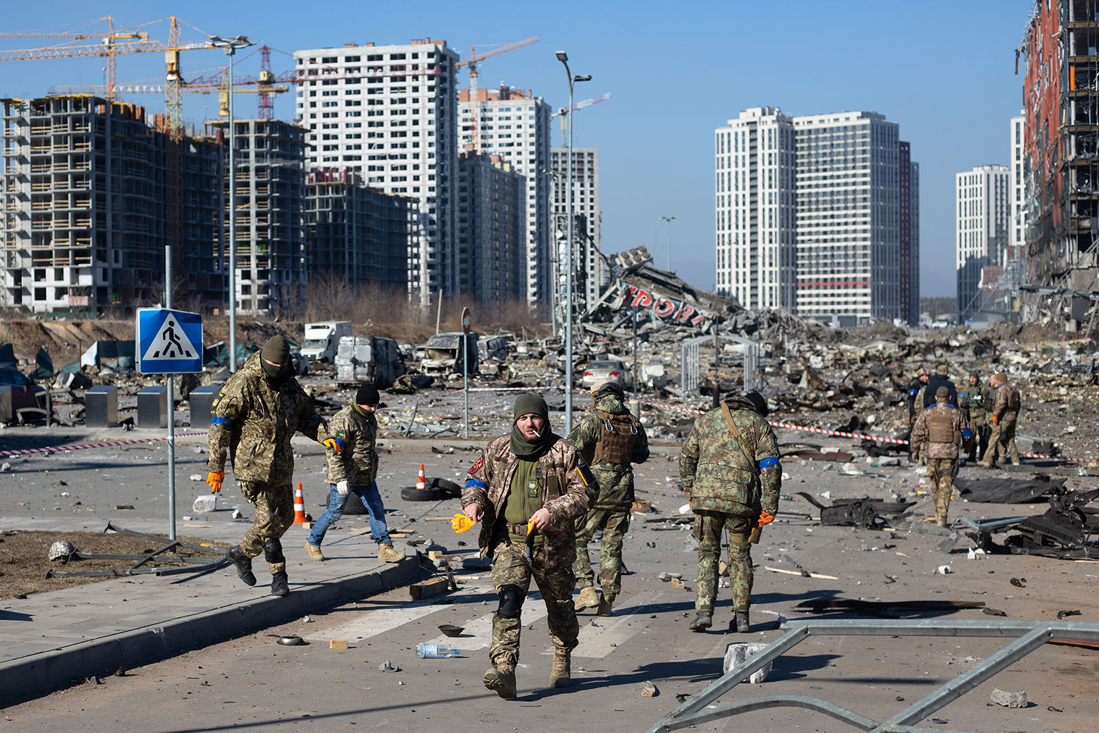 Ukrainian servicemen are seen at an explosion site of a shopping center on March 21 in Kyiv. 