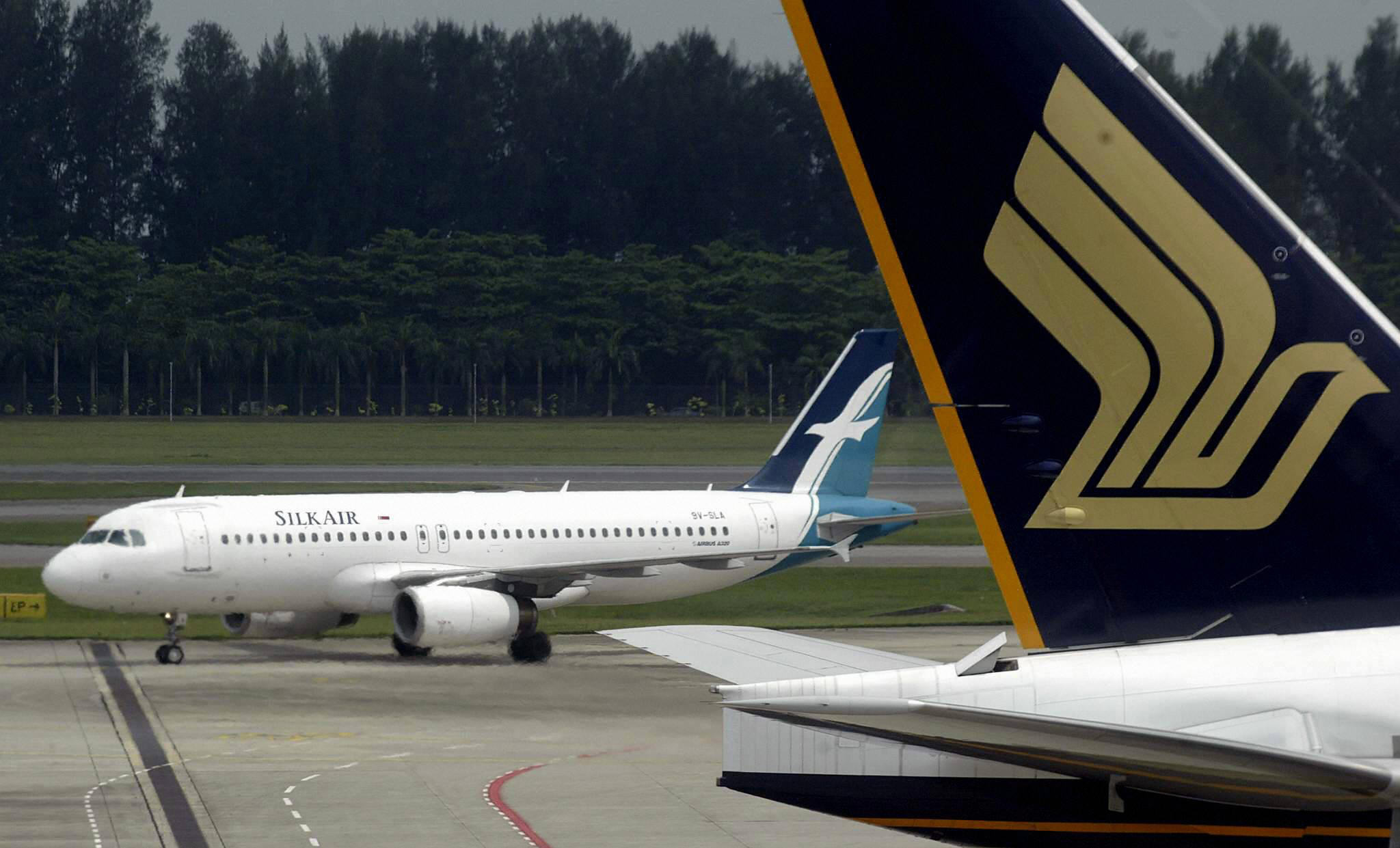 A Singapore Airlines (SIA) plane and its subsidiary SilkAir plane -- not one of its six MAX 8 planes -- taxiing at Changi International Airport, Singapore. 