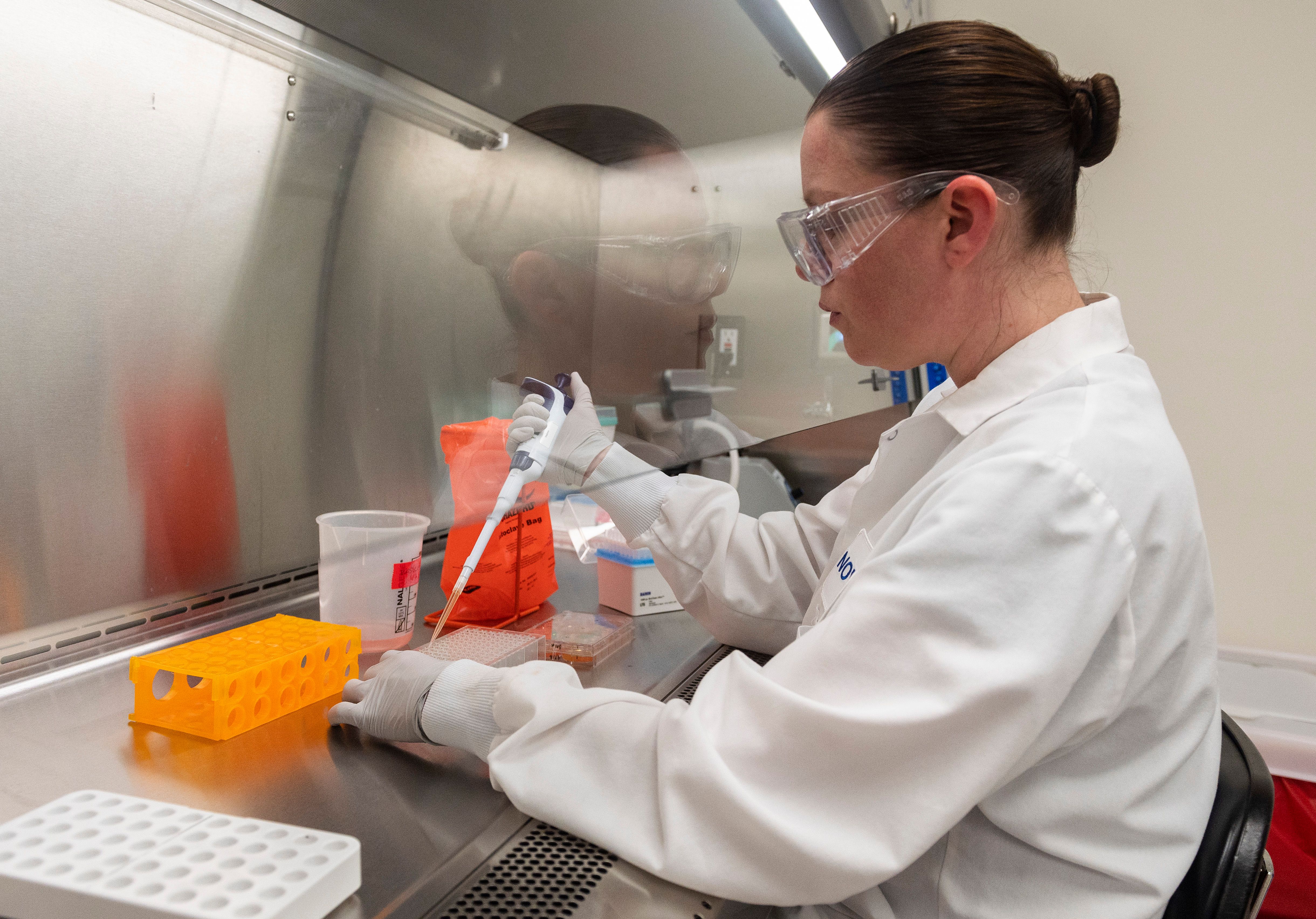 Dr. Rhonda Flores looks at protein samples at Novavax labs, which is developing a vaccine for the coronavirus, in Rockville, Maryland, on March 20.