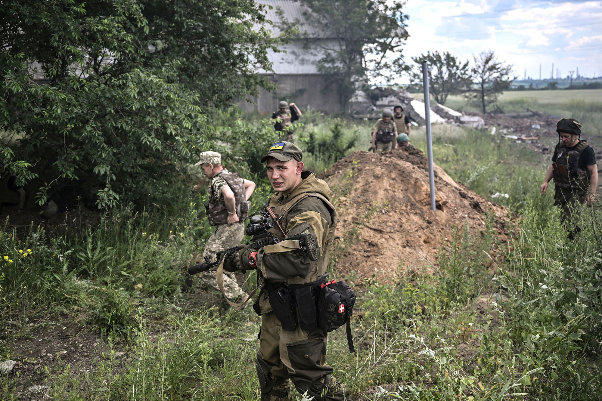A Ukrainian serviceman looks on after a strike on a warehouse on the outskirts of Lysychansk, in the eastern Ukrainian region of Donbas, on June 17.