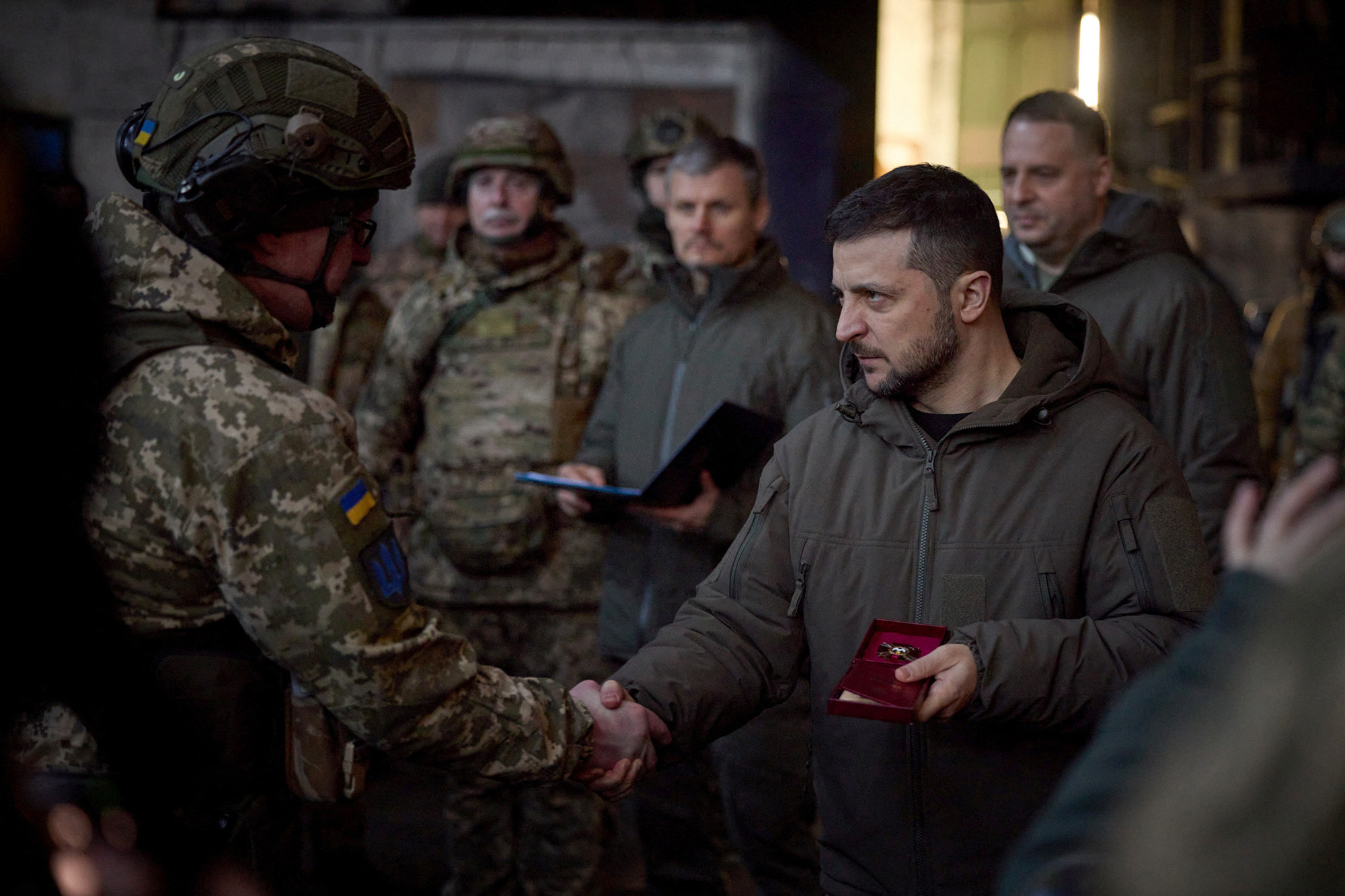 Ukraine's President Volodymyr Zelenskiy awards a Ukrainian service member at a position in the frontline town of Bakhmut, Ukraine, on December 20.