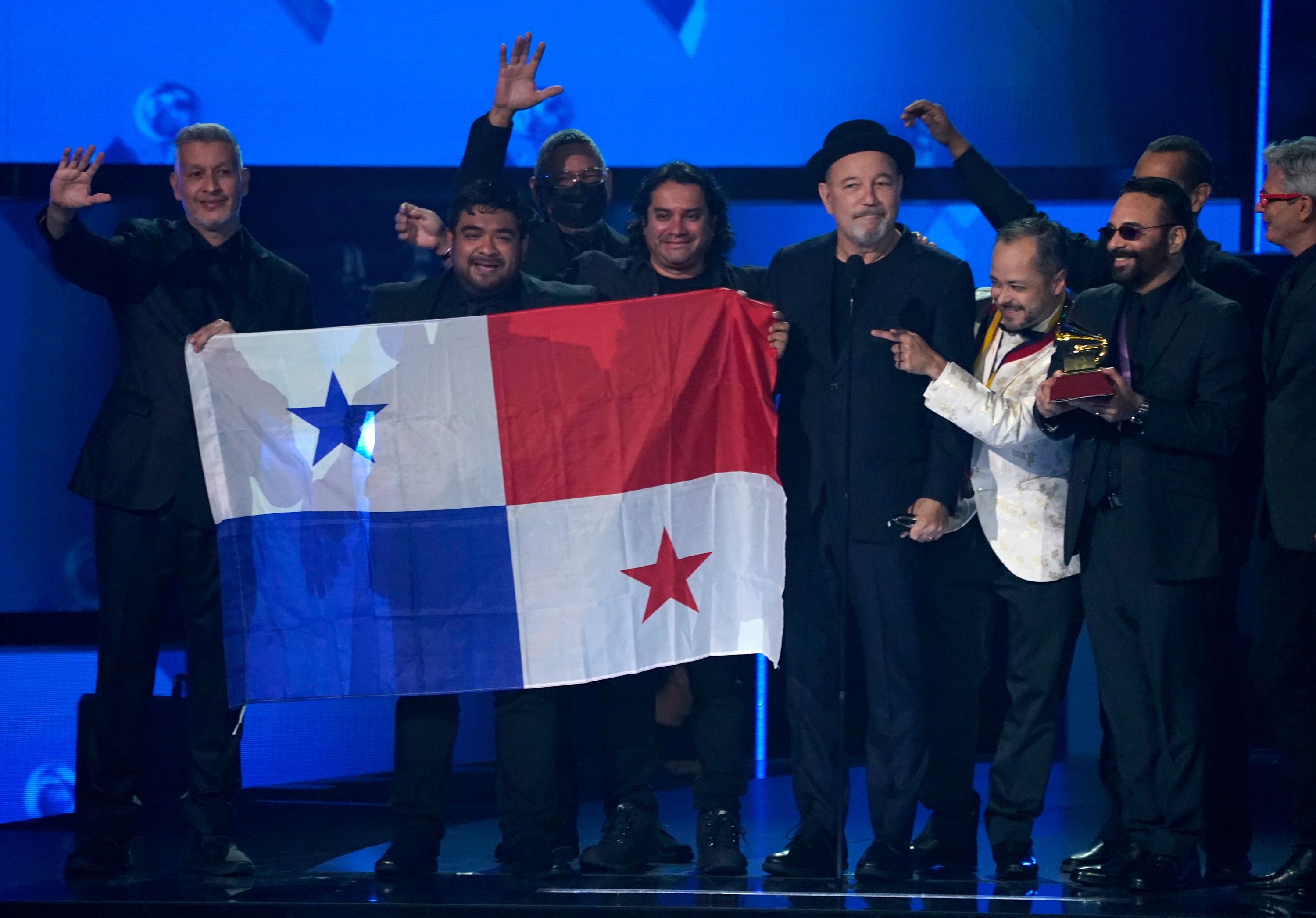 Ruben Blades, third from right, Roberto Delgado, right, and his orchestra accept the award for album of the year for "Salswing!" while holding up the flag of Panama.